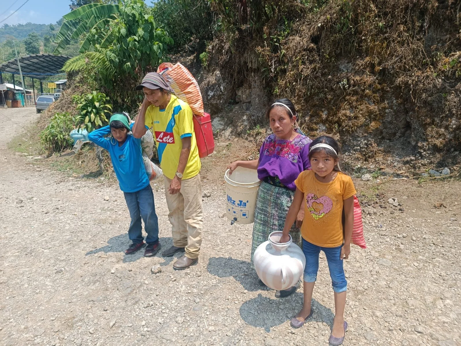 FAMILY COLLECTING WATER - Greg Dirks.jpg