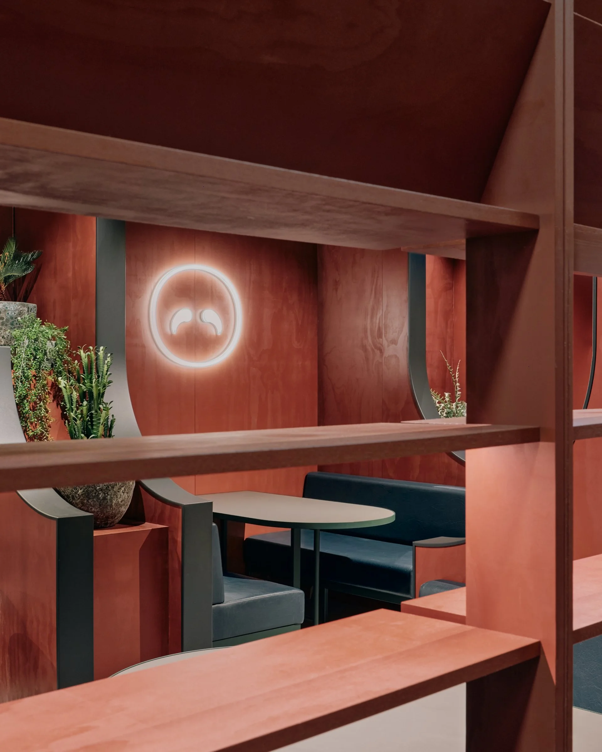  Mirrored surfaces amplify this rhythm, reflecting booths, lighting, planting and colour to create unexpected perspectives and a continuous sense of depth. What initially appears to be a narrow space becomes layered and visually expansive. 