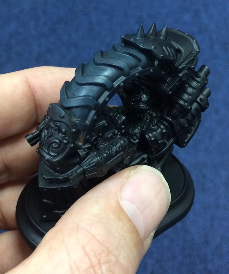 Over a black undercoat, the tire is overbrushed with neat Coal Black with a large flat brush. Overbrushing is exactly like drybrushing, you just don't need to wipe off as much paint. This will give the rubber a rough look from the start.