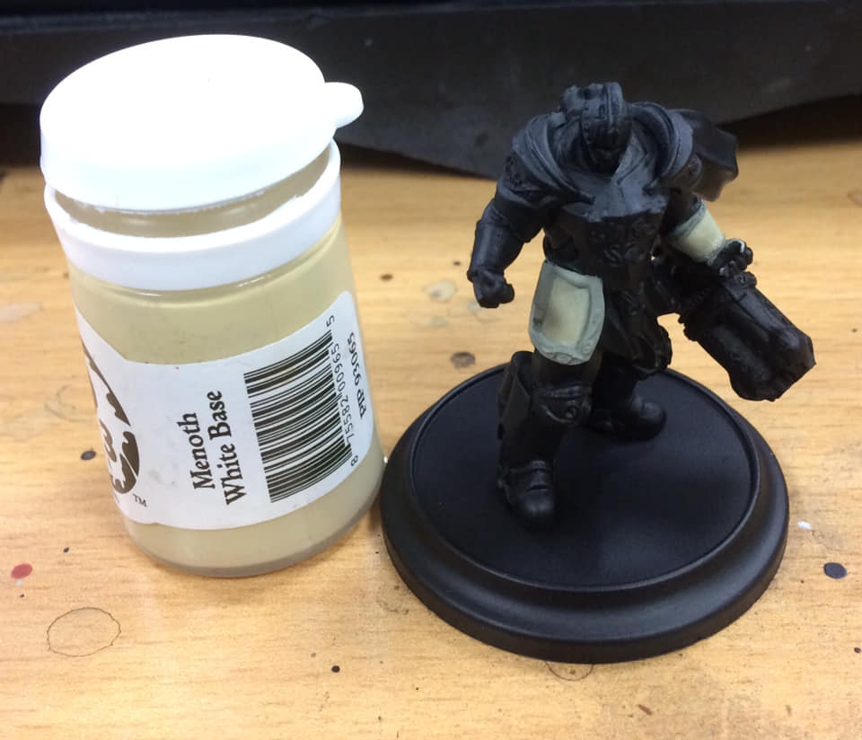 Block the panels in with Menoth White Base but leave a little of the previous colour showing in the recesses as shading.