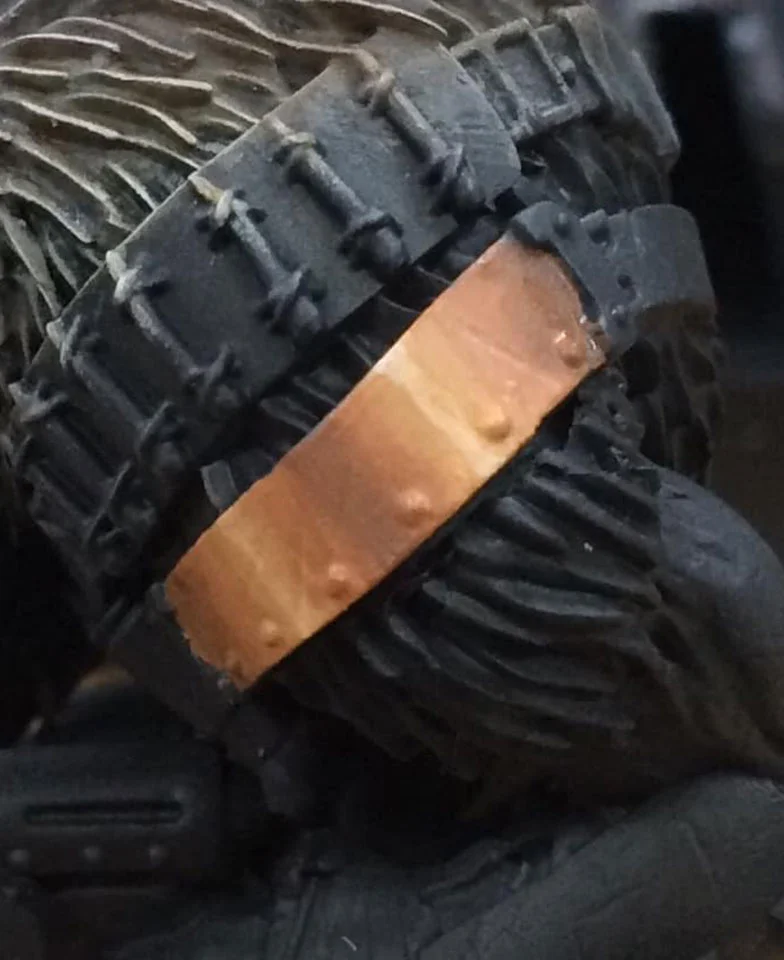 We begin our shadows by adding a touch of Umbral Umber to our basecoat mix. This is blocked in between our light bars and towards the edges of the plate.