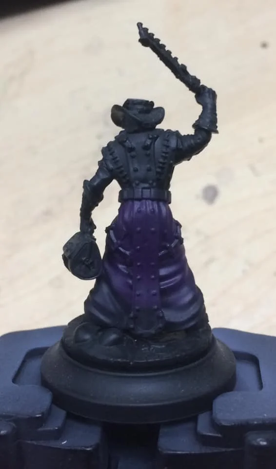 Starting a quarter of the way up the model a coat of 1:2 Beaten Purple and water was applied to the entire area.