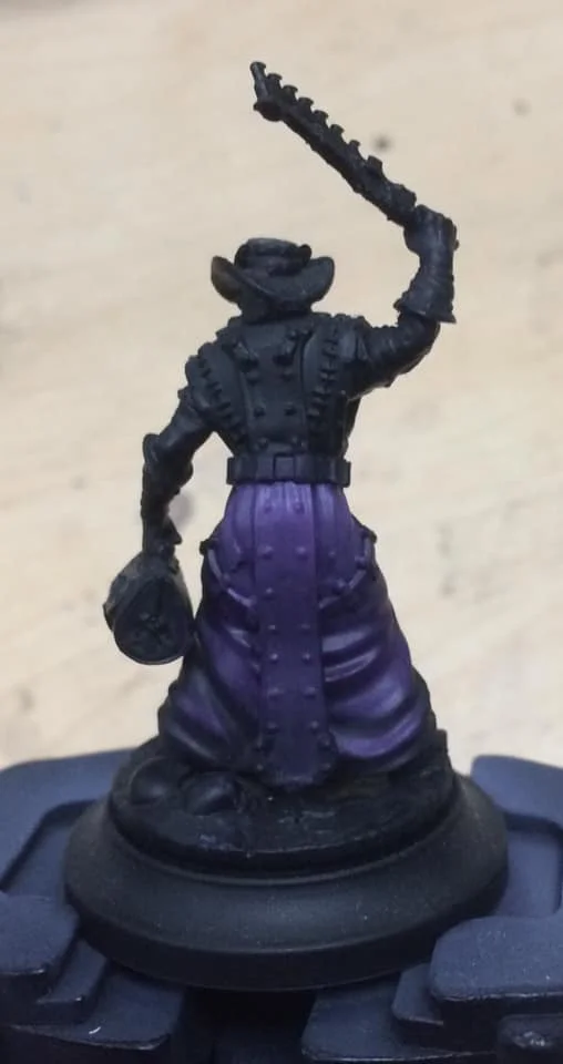 Starting three quarters of the way up the robes the area was painted 1:1:2 Beaten Purple, Menoth White Base and water.