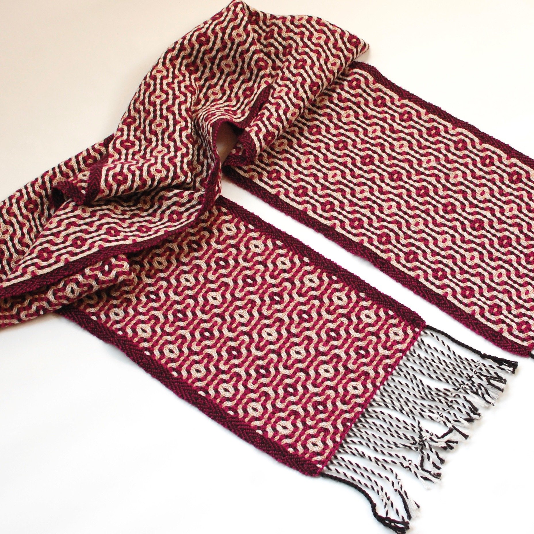 A handwoven scarf showing two sides of the same cloth. Made in New England. Handowoven