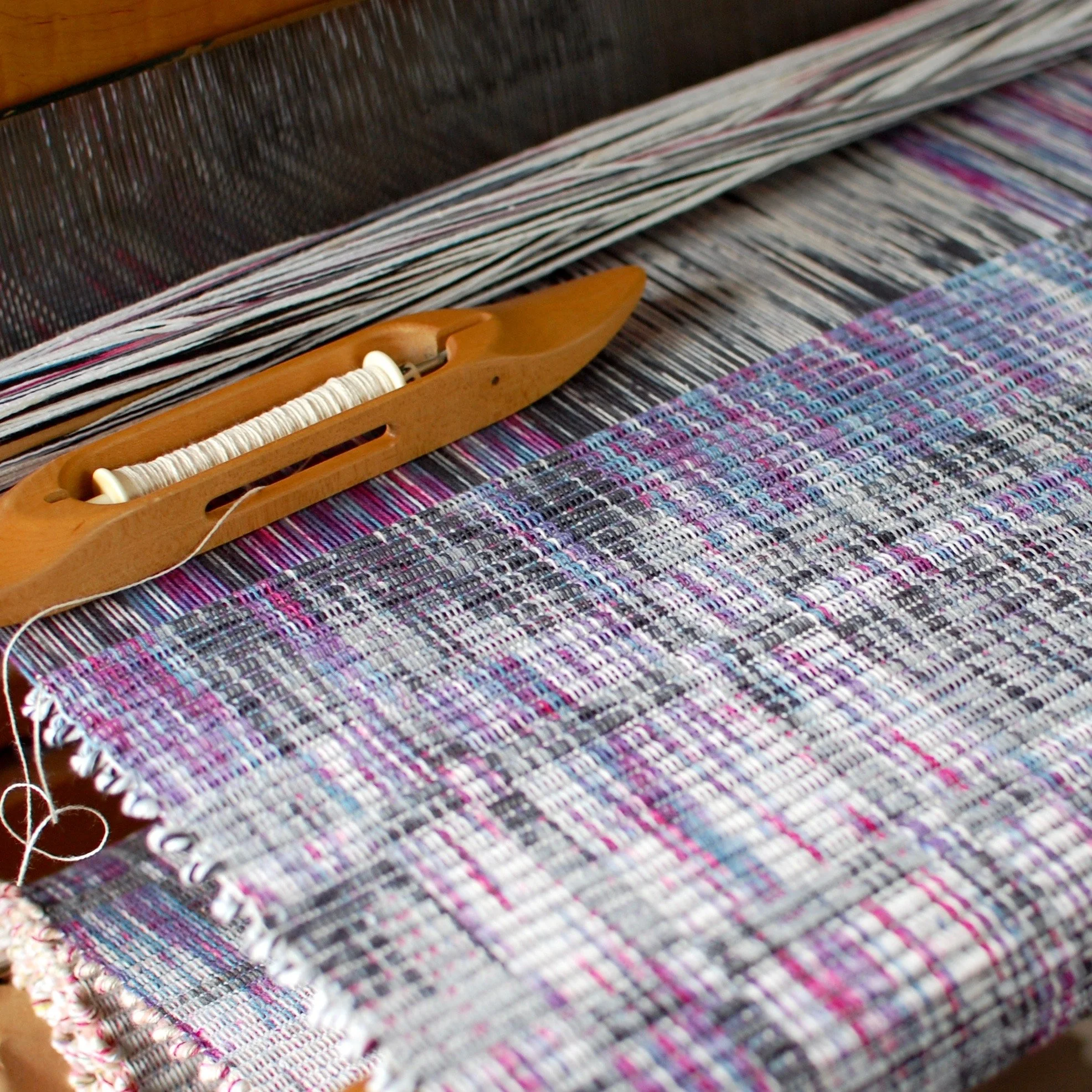 Rep weave rug being woven on the loom with a hand-dyed warp.