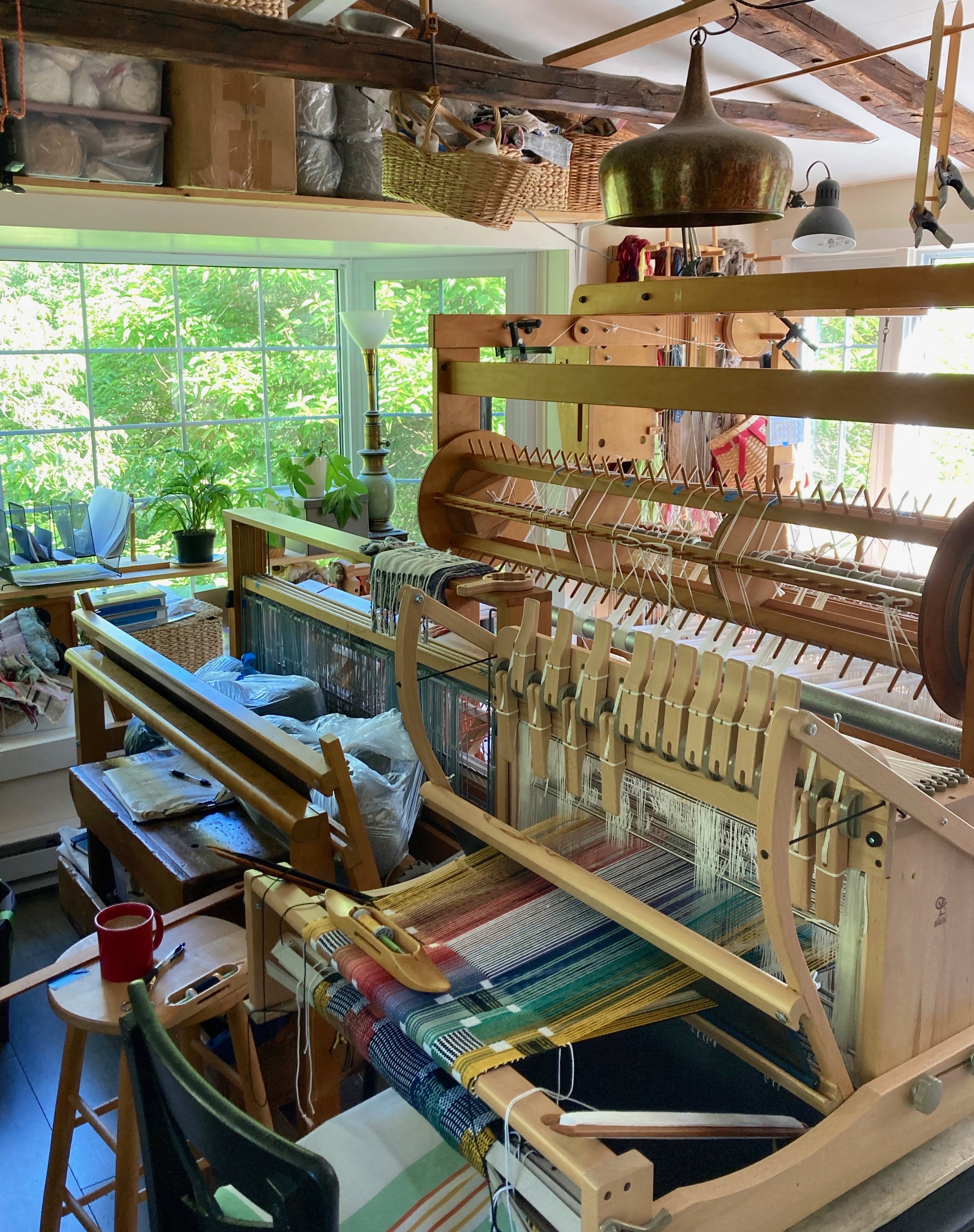 The current state of my weaving studio. A 16H Ashford Table loom sits in front of the 4H LeClerc, with a 60" 16H AVL crammed in behind.