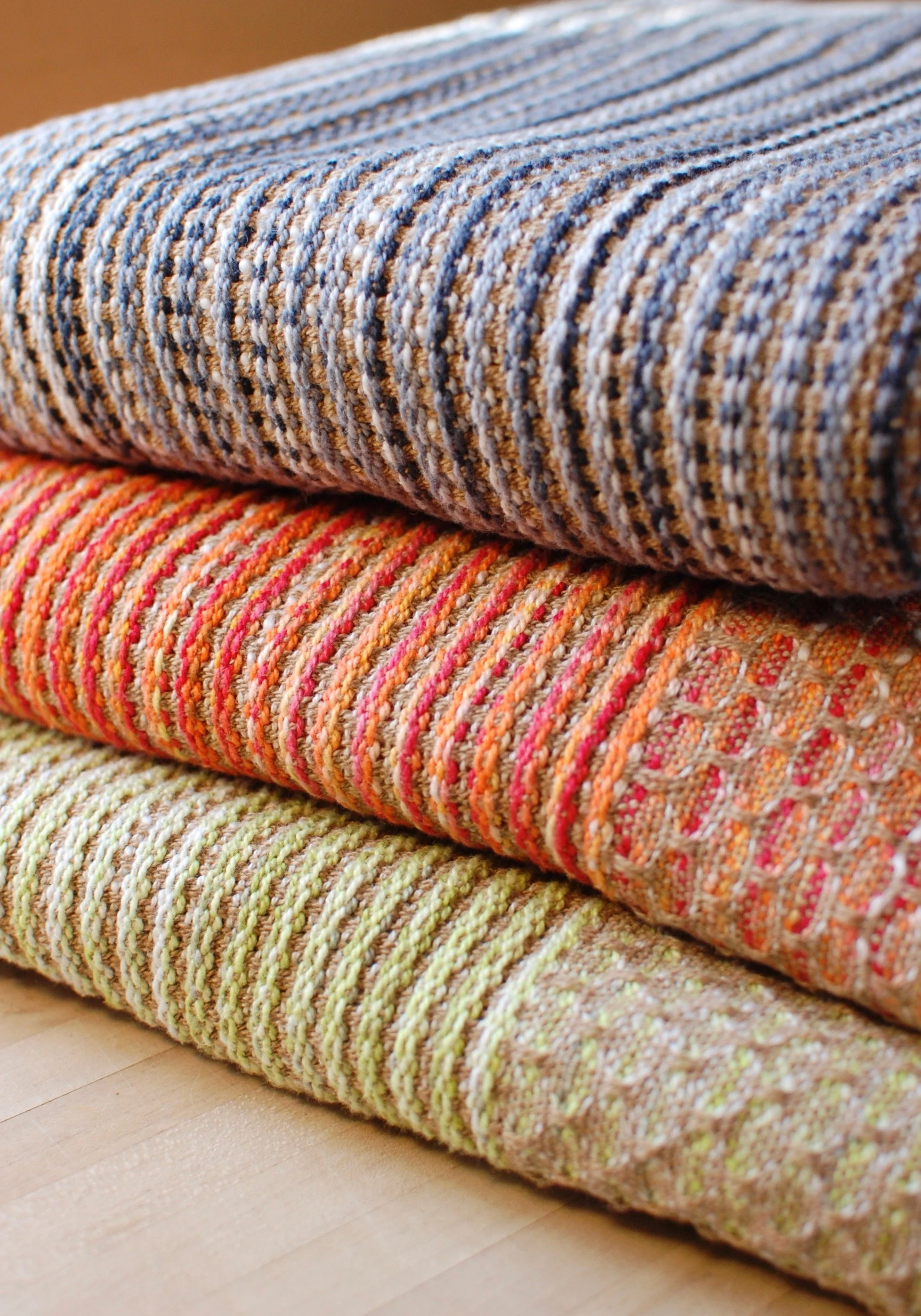 A stack of custom handwoven throw blankets