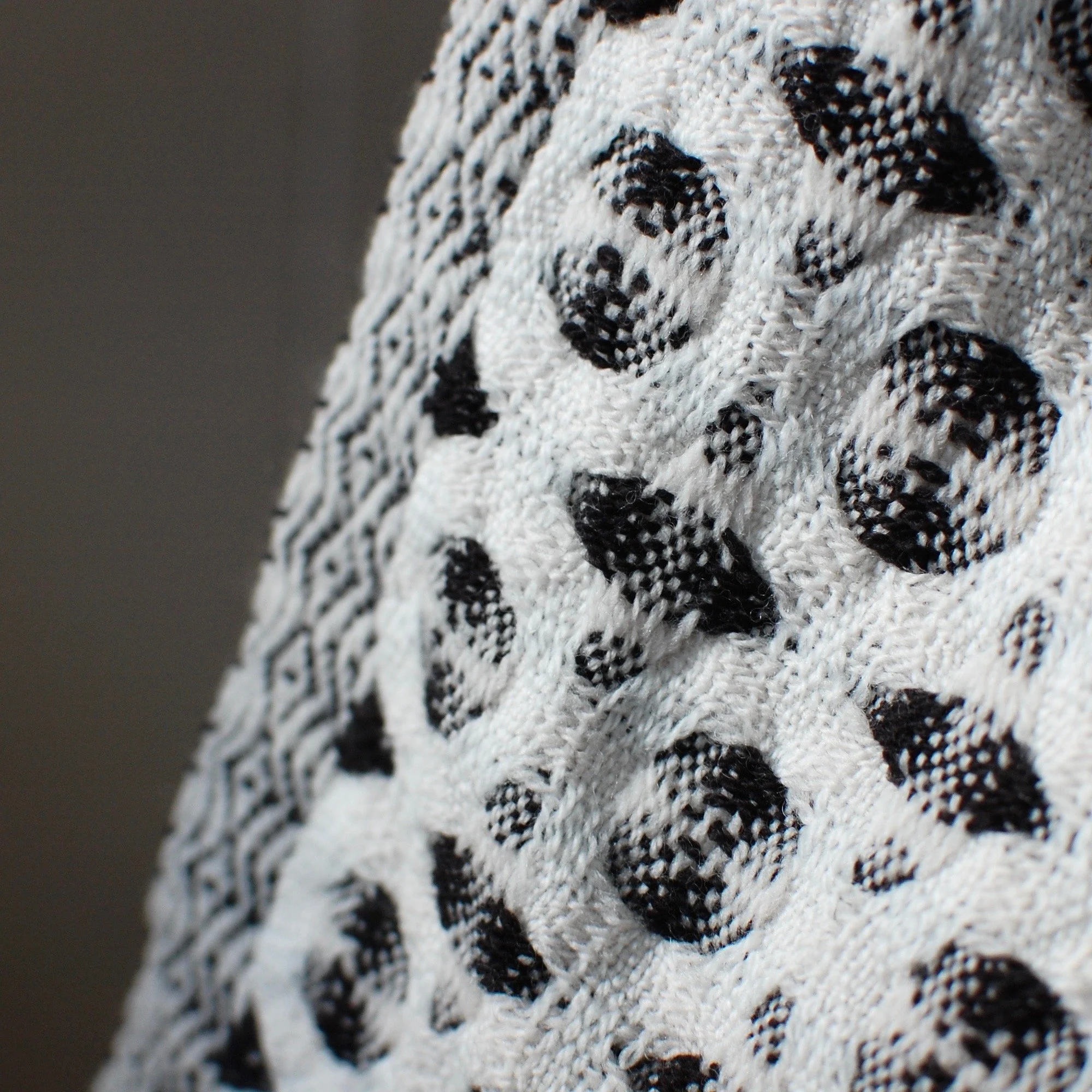 detail of a modern design handwoven textile in merino