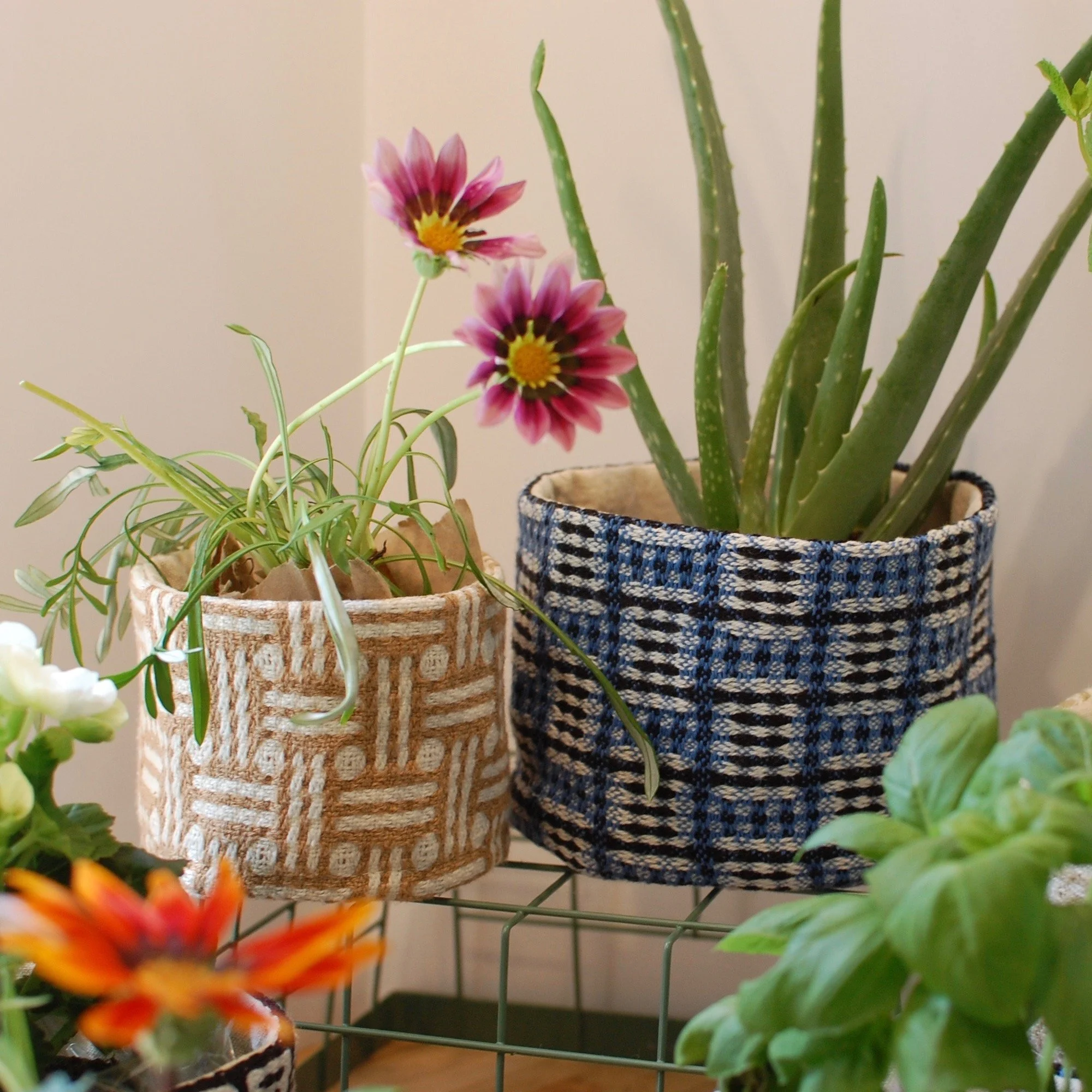 Unique handwoven cloth plant covers.