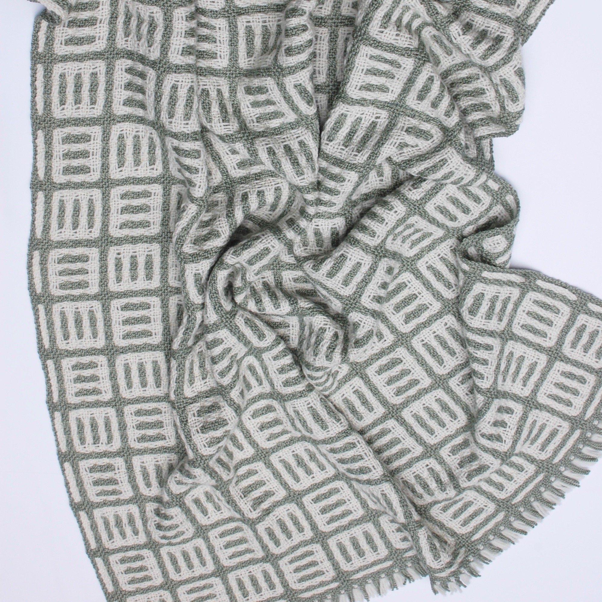 Natural fibers handwoven lap blanket sage green and cream.