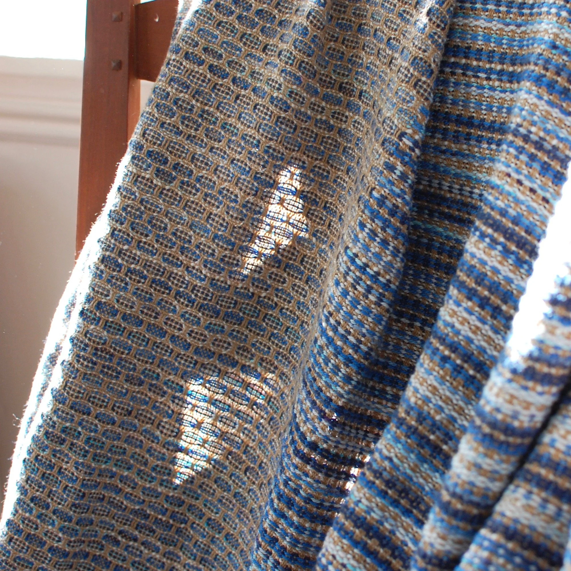 Light shining through a handwoven custom throw blanket that is made in America small batch