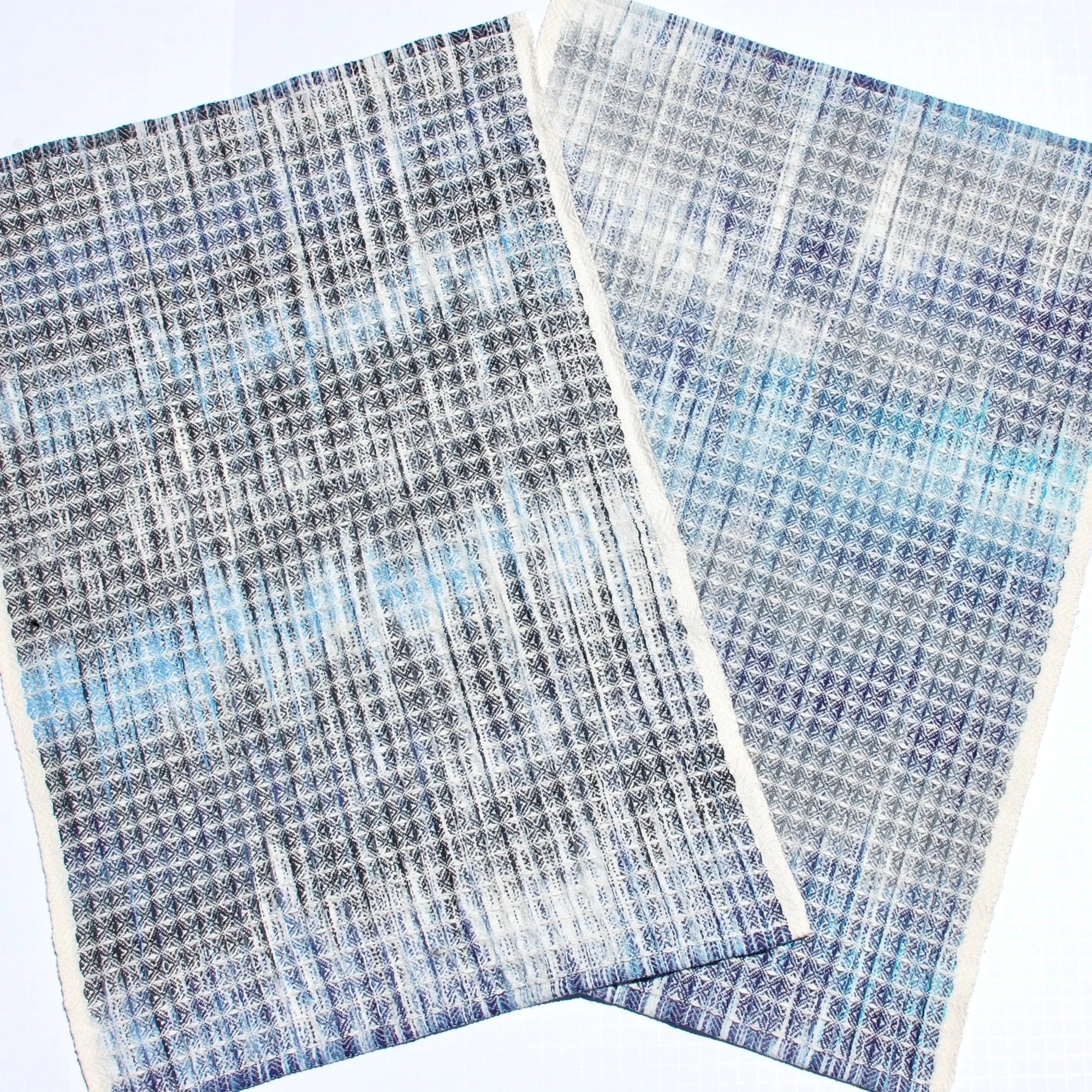 A pair of handwoven towels in blue with beach and coastal inspiration colors