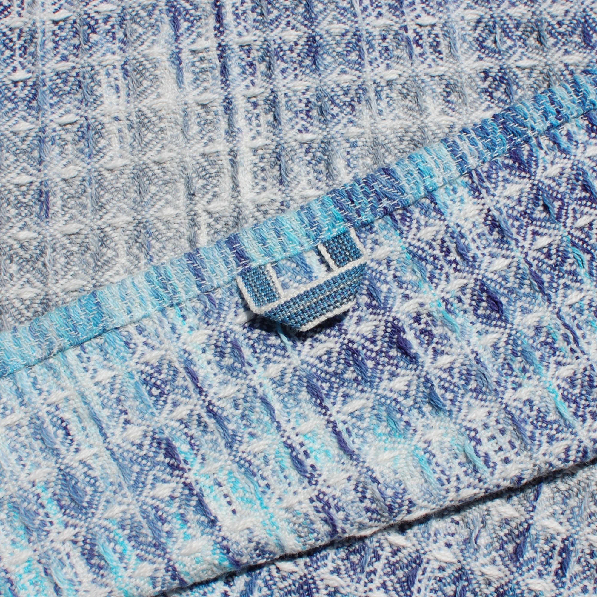 Blue handwoven towels with an Inkle loom woven hand loop