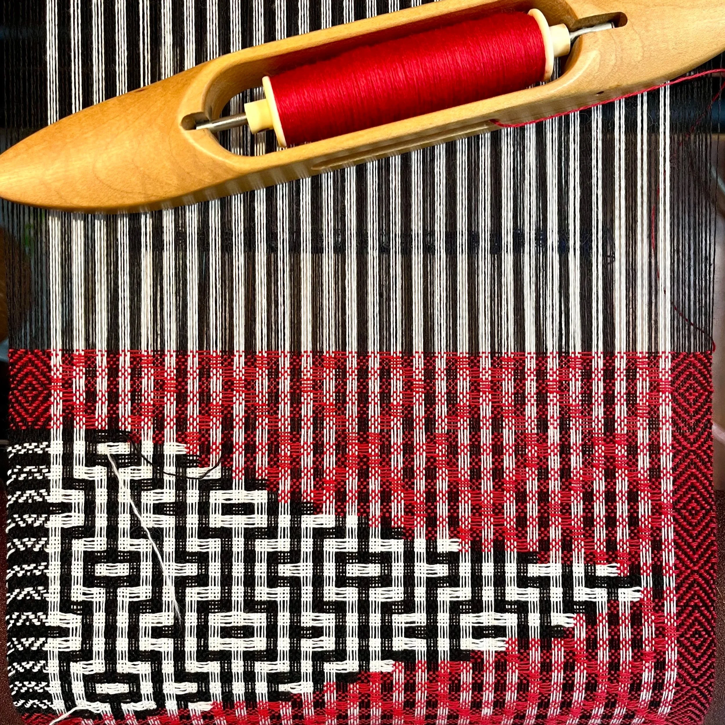 black red and white handwoven scarf on the loom. Modern design scarf. Deflected doubleweave