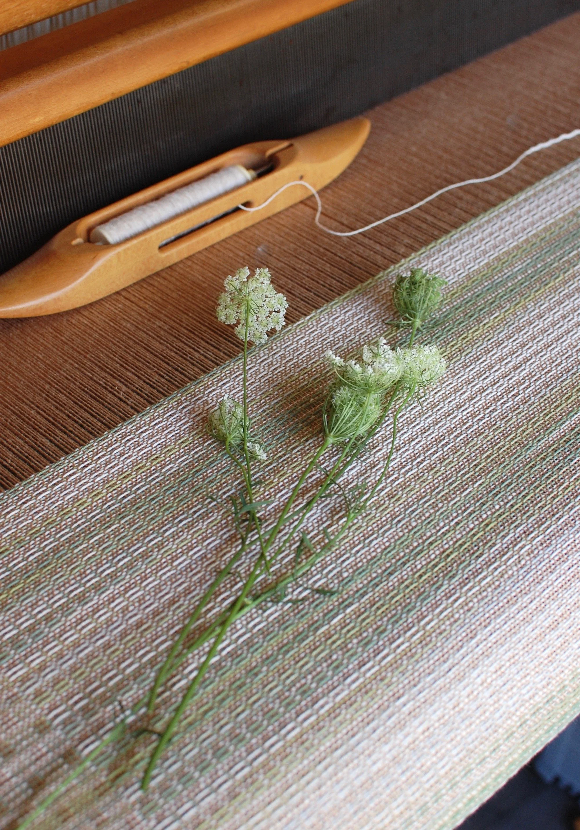 Custom blanket inspired by wild flowers being woven on an AVL loom made in America