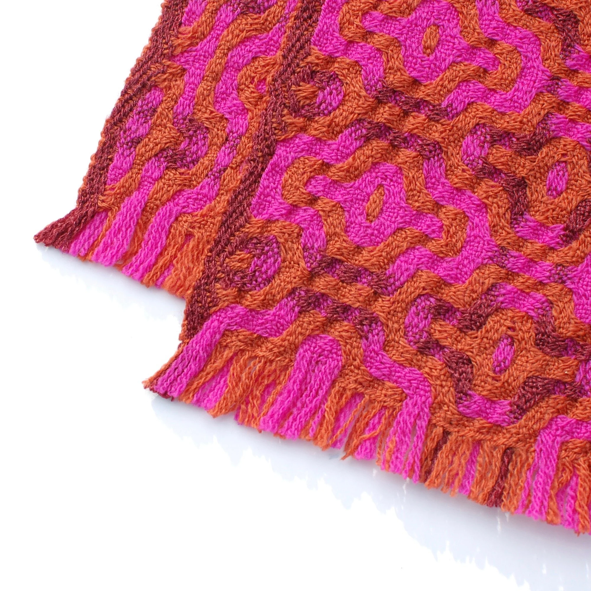 fringe cut very short on a scarf that is pink