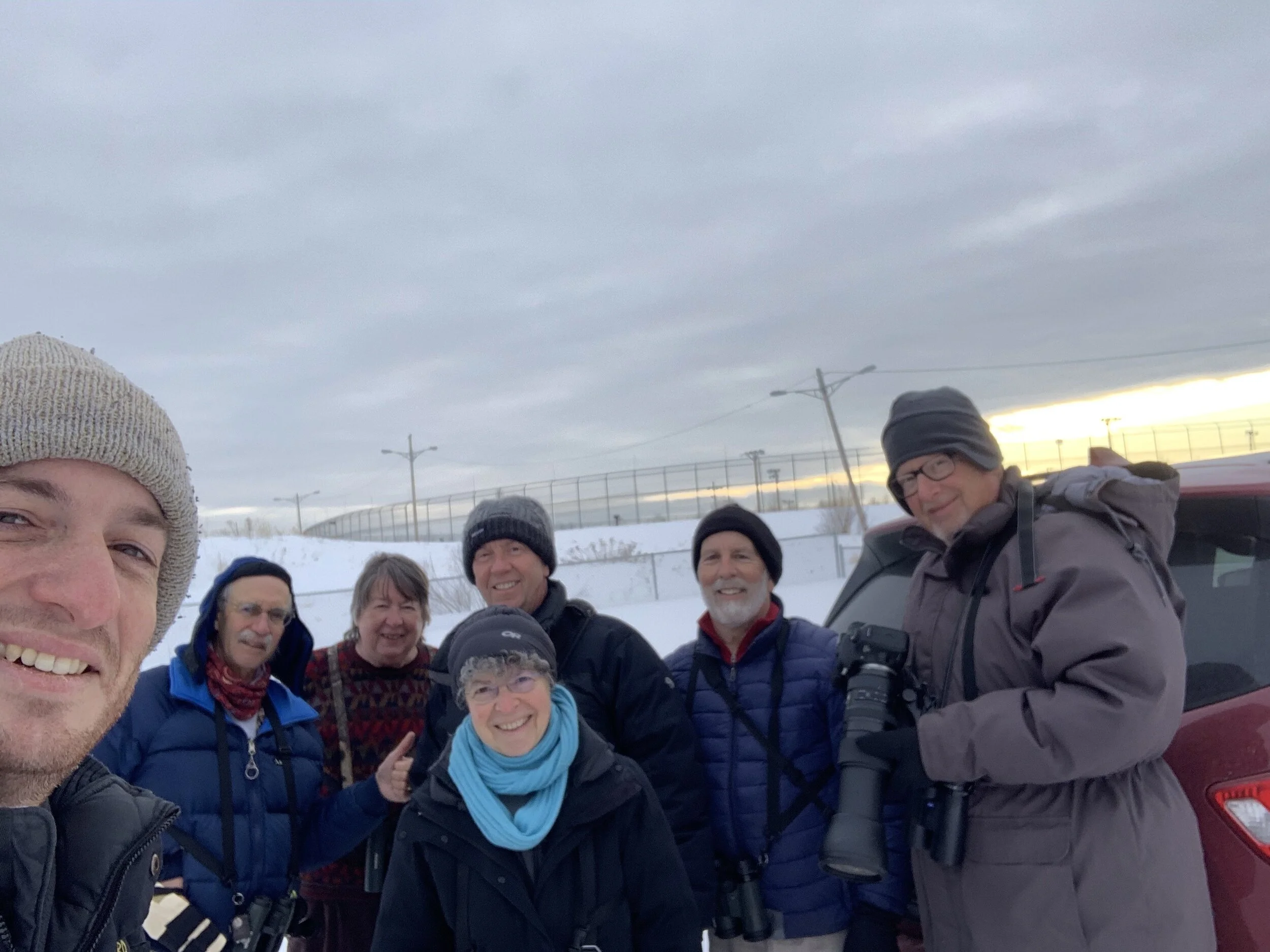 There's a Snowy Owl on a pole behind the group!