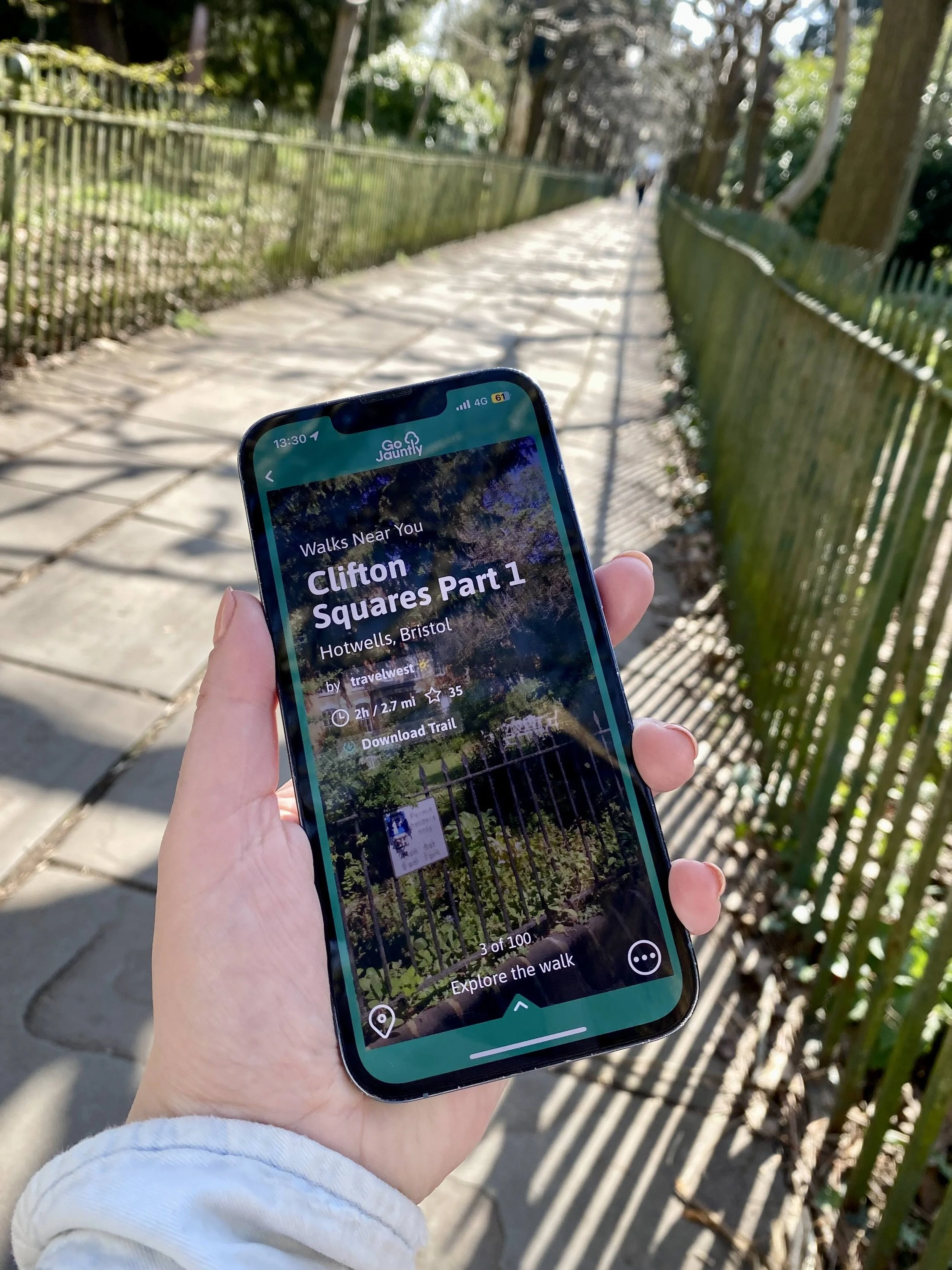 A phone in hand, showing one of the Clifton Squares walks in Bristol