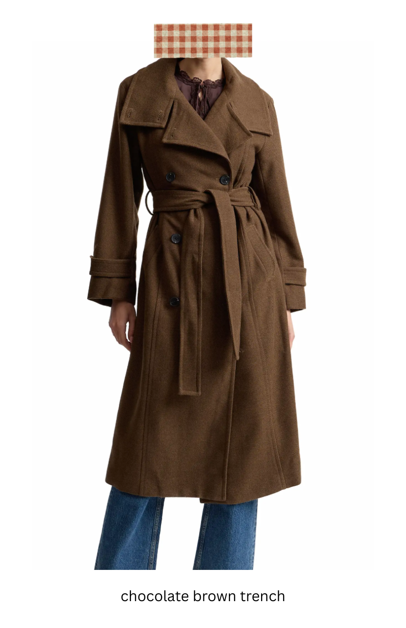 Woman wearing a brown trench coat with jeans.