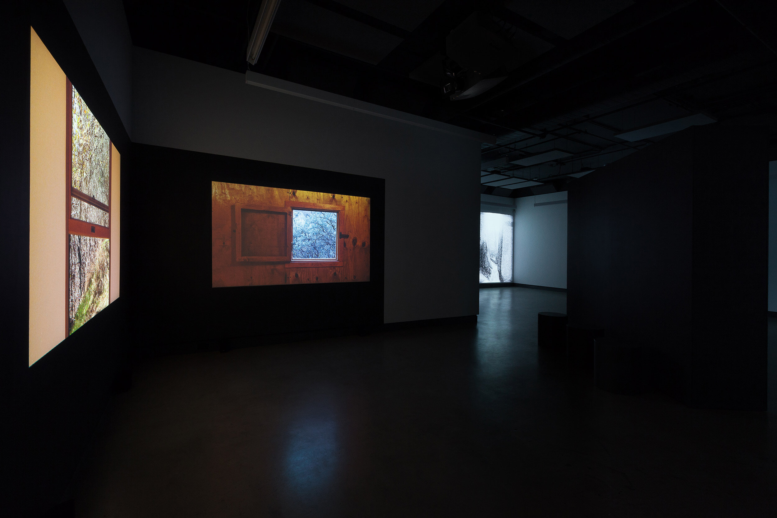  © James Benning,  Two Cabins  (2011). Installation view of the exhibition, Dazibao, 2018. From left to right: James Benning, Miriam Sampaio. Photo: Marilou Crispin. 