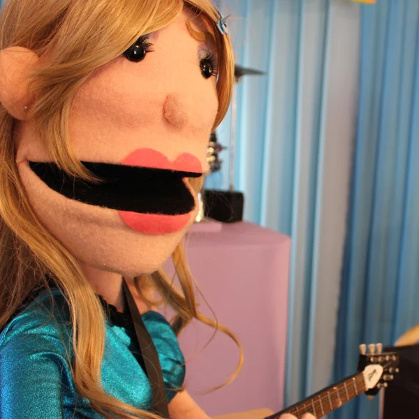 Sings + Plays Guitar