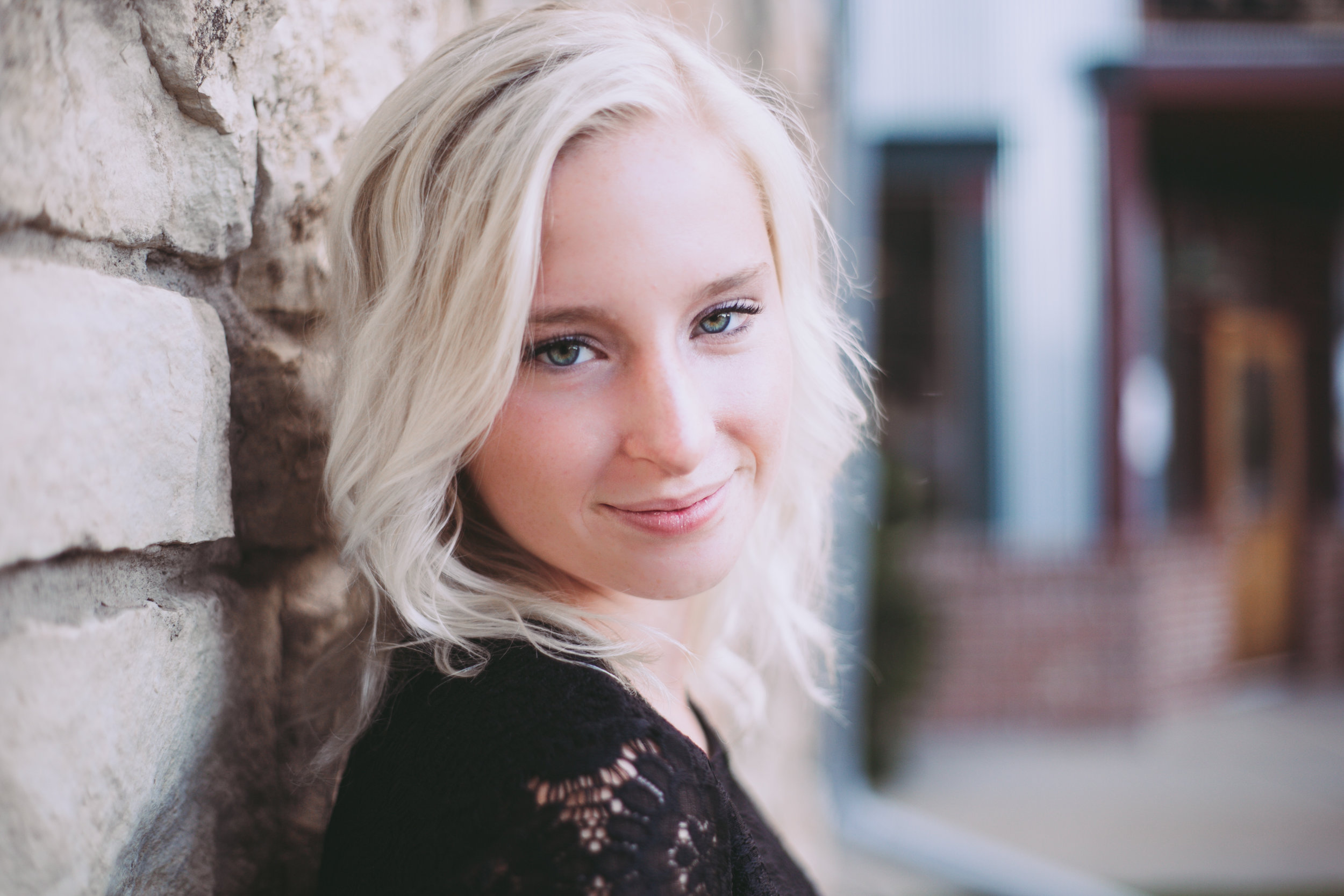 Baldwin WI high school senior poses against brick wall in Stillwater MN