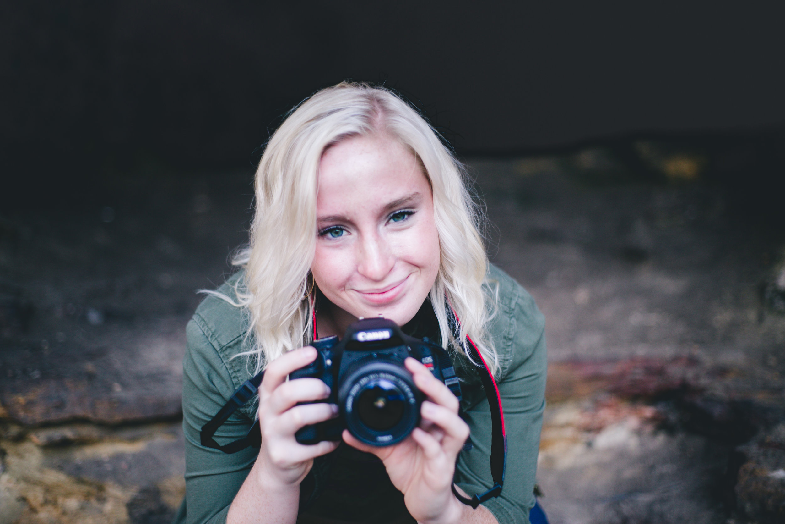 Blonde holds a Canon camera