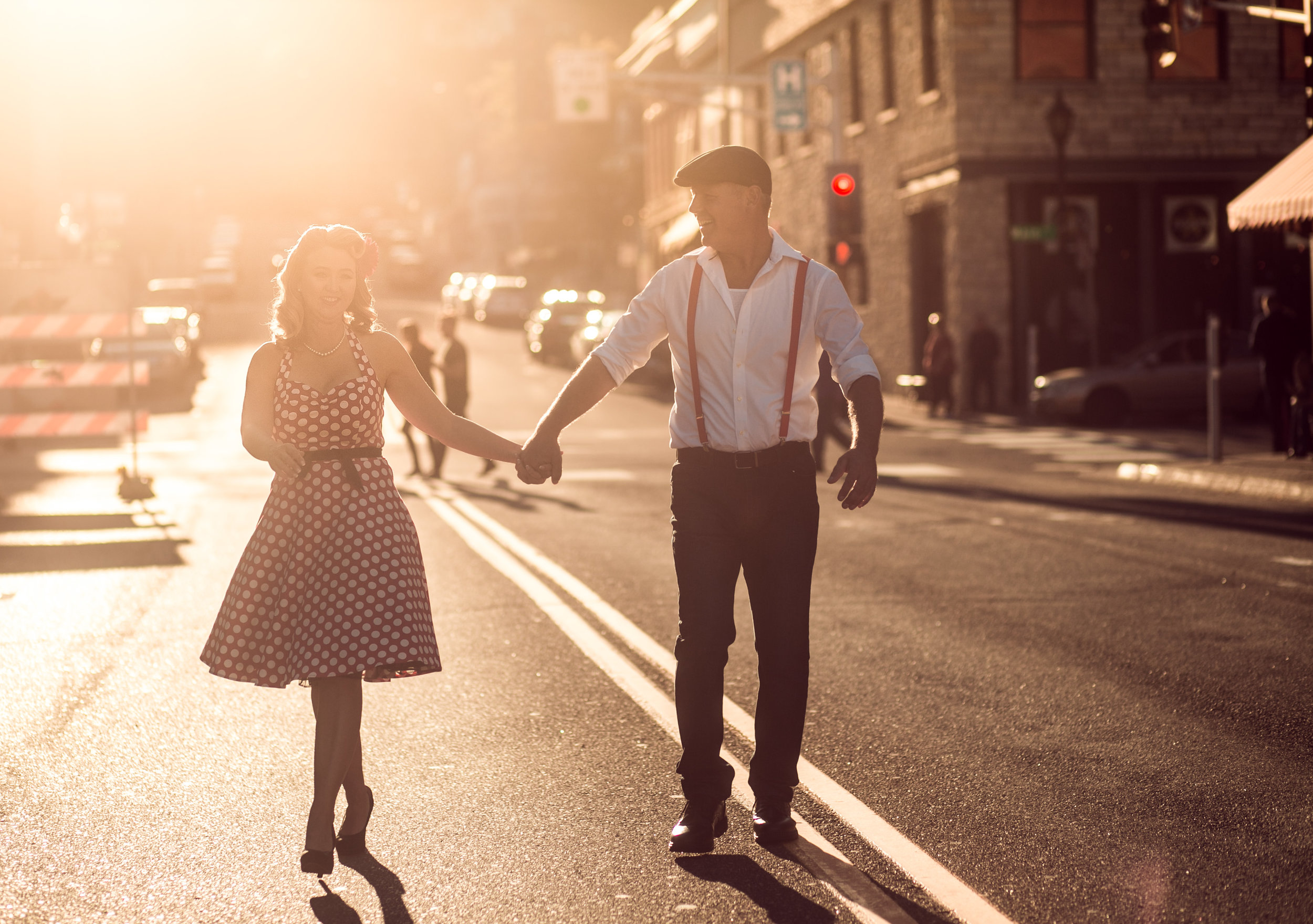  a couple dances in the golden sunset in downtown Stillwater MN during their engagement session 