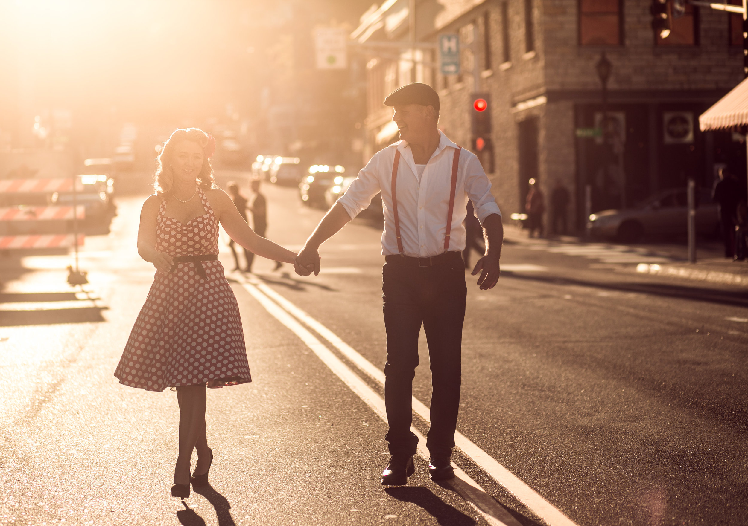 a couple dances in the golden sunset in downtown Stillwater MN during their engagement session