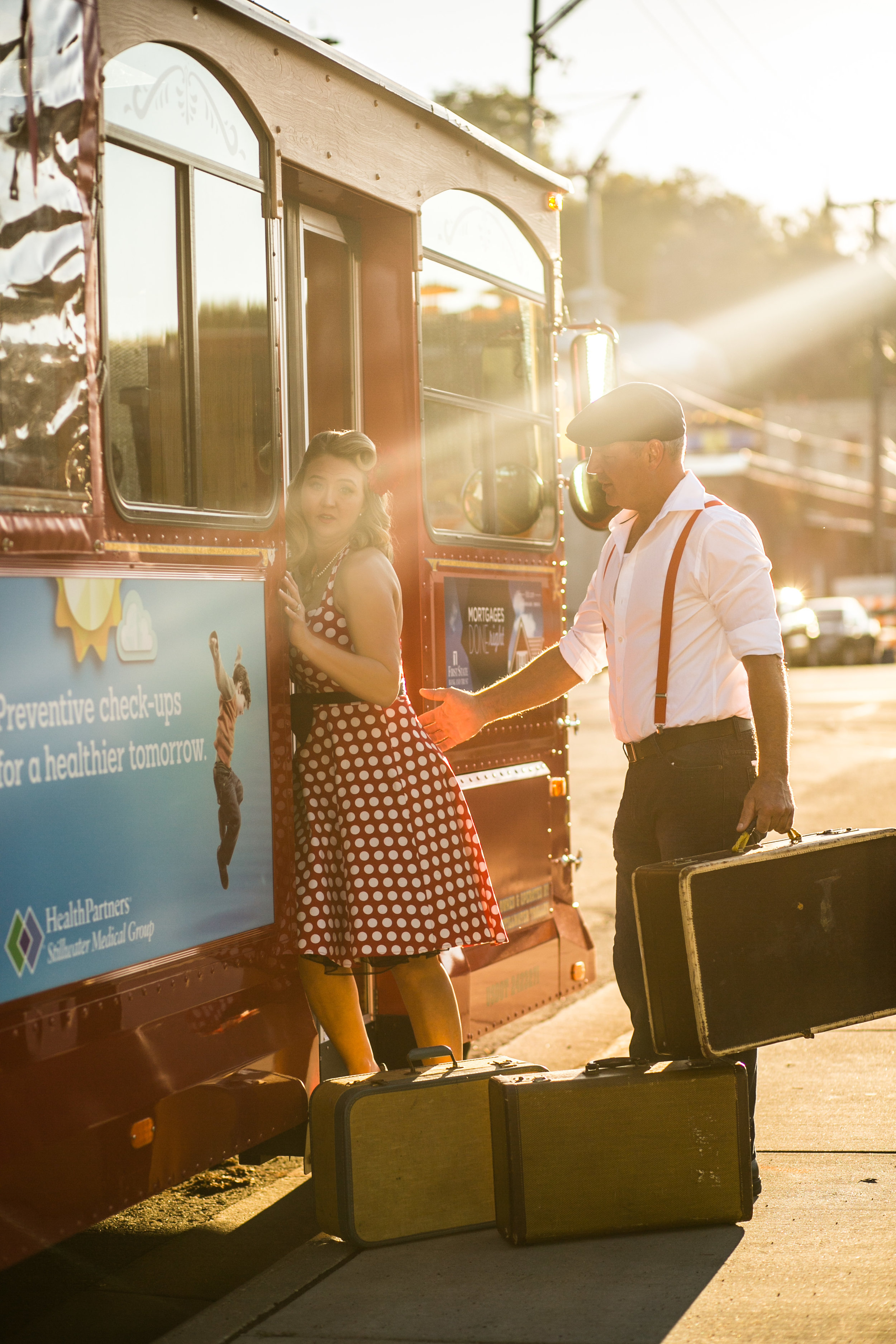  Vintage 1940's looking couple poses in front of Stillwater Trolley in the sunset causing flares 
