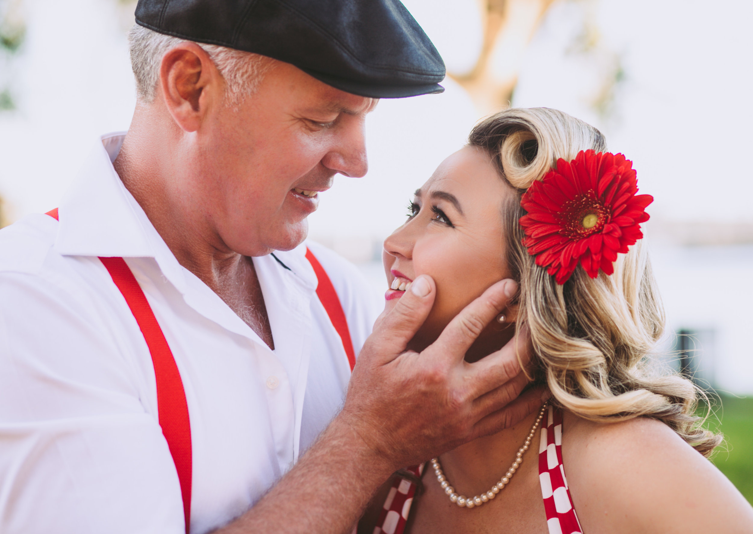 Man holds finance's face about to kiss her