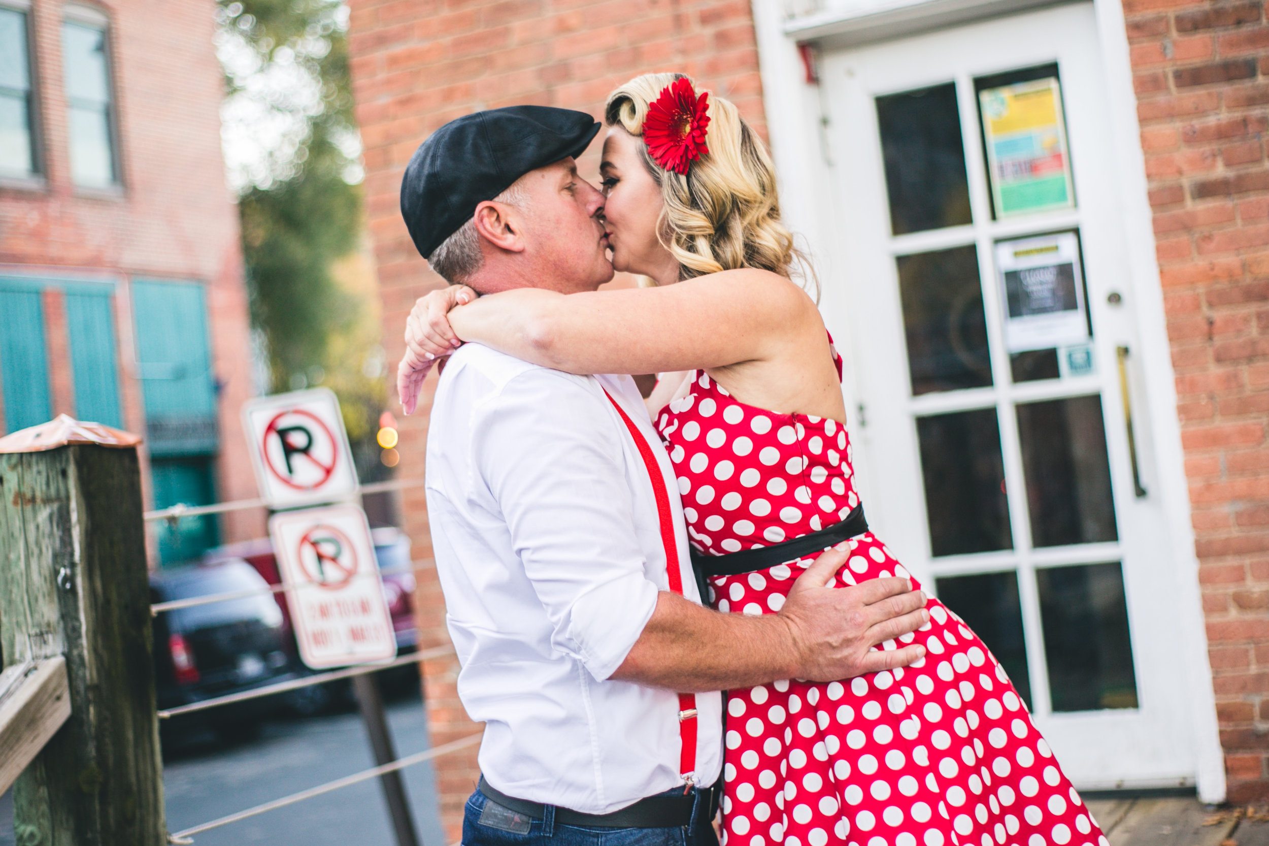 Woman kisses man in front of Freight House in Stillwater