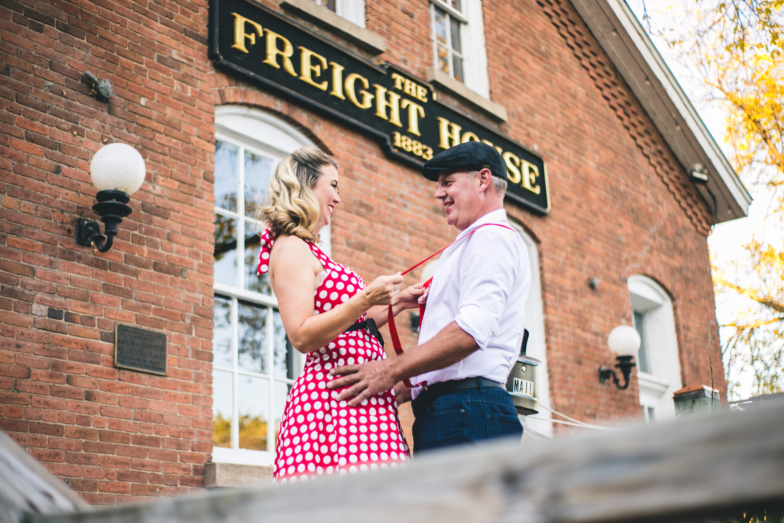 Man and Woman flirt in front of Freight House in Stillwater