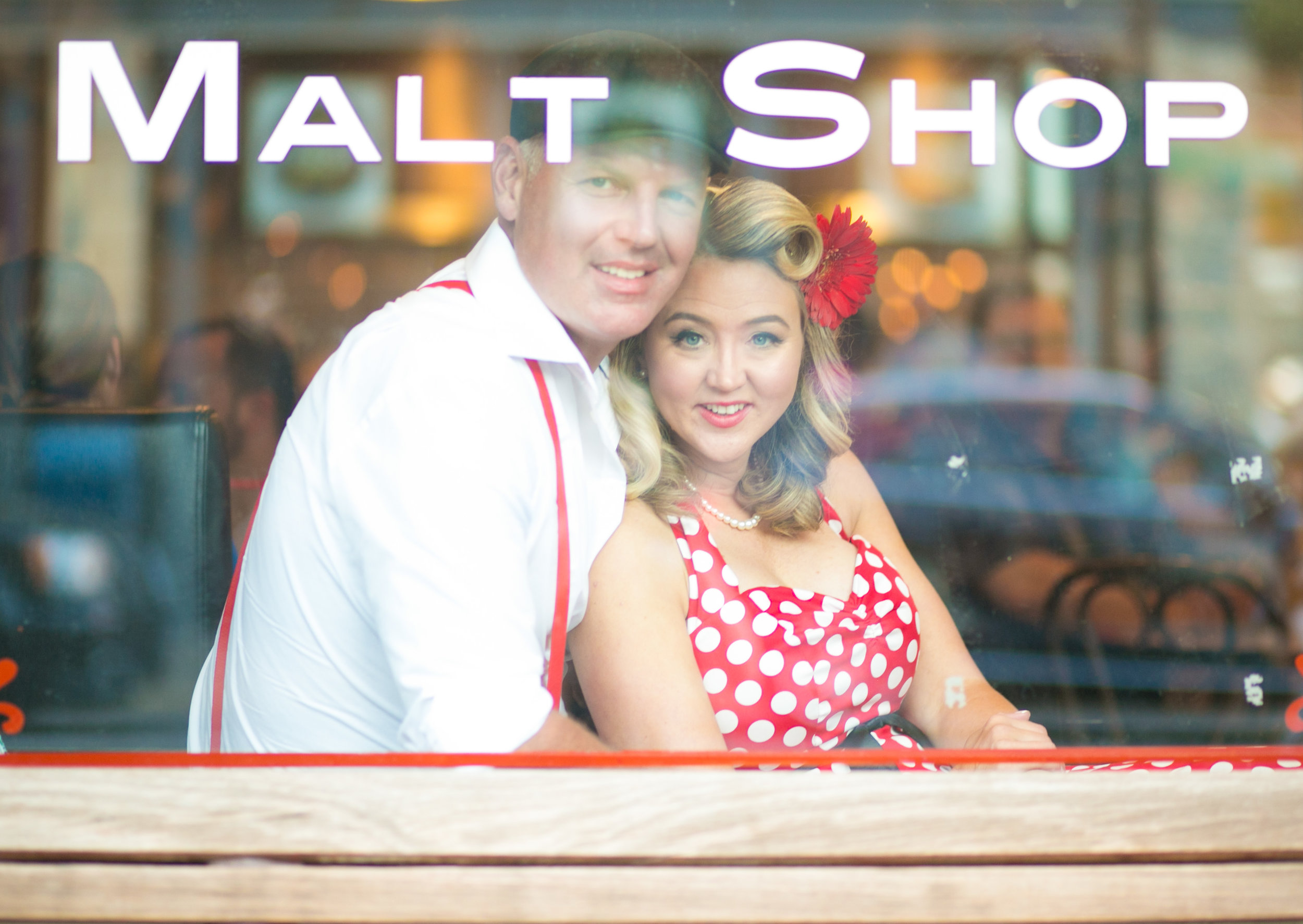 Man and woman smile through the window of Leo's Ice Cream in Stillwater