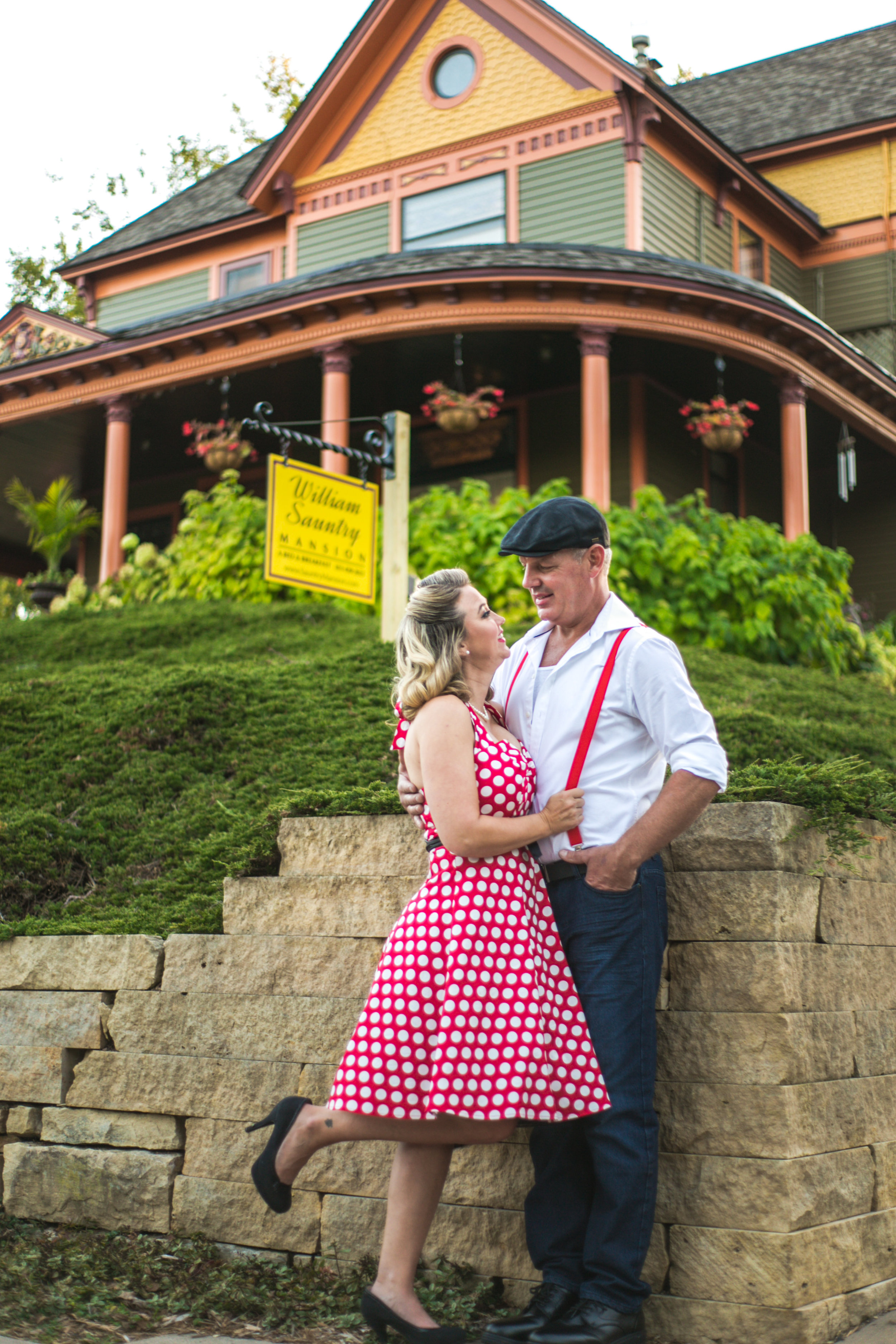 Couple poses in front of The William Sauntry Mansion in Stillwater