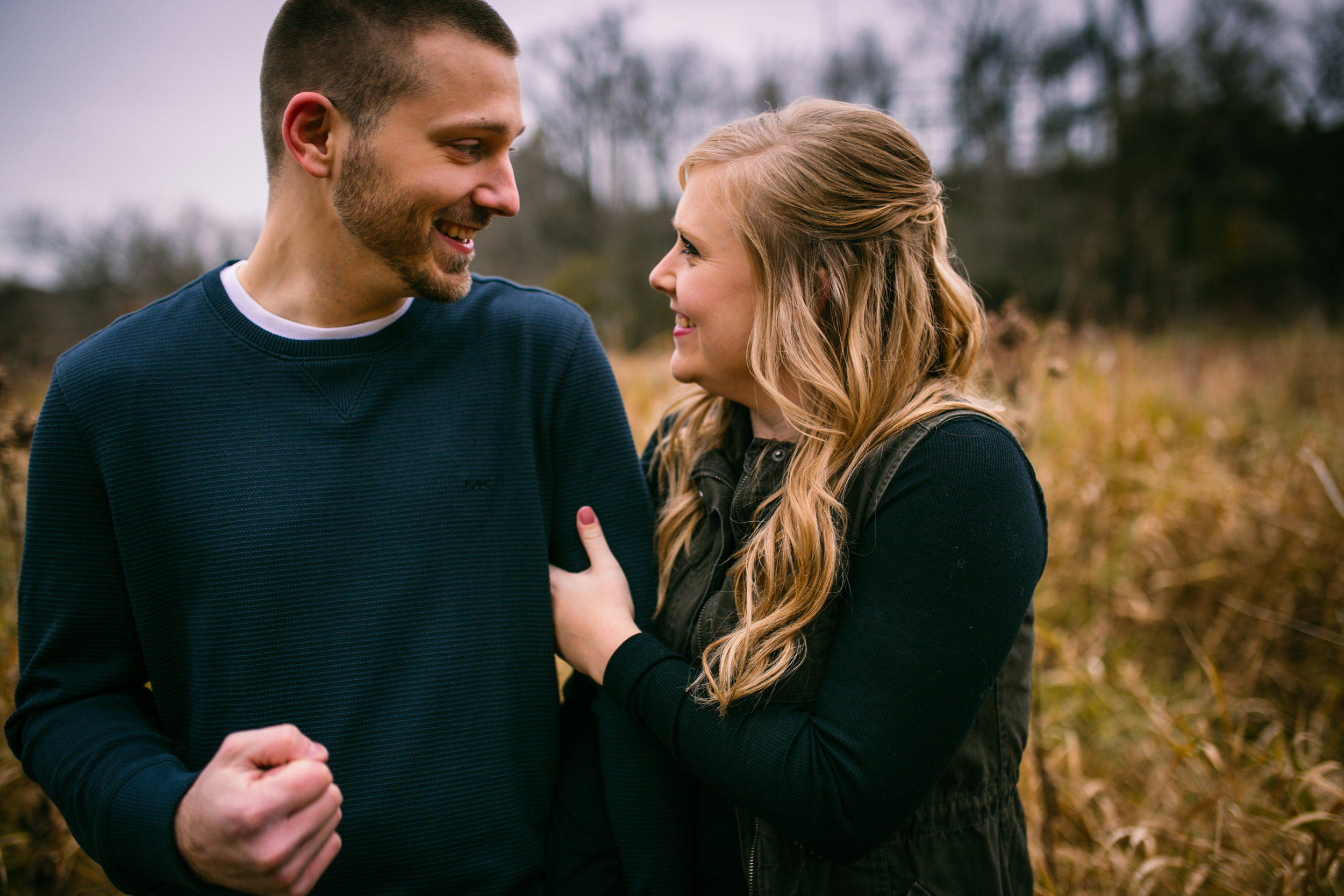 engaged couple smiling and laughing in River Falls WI