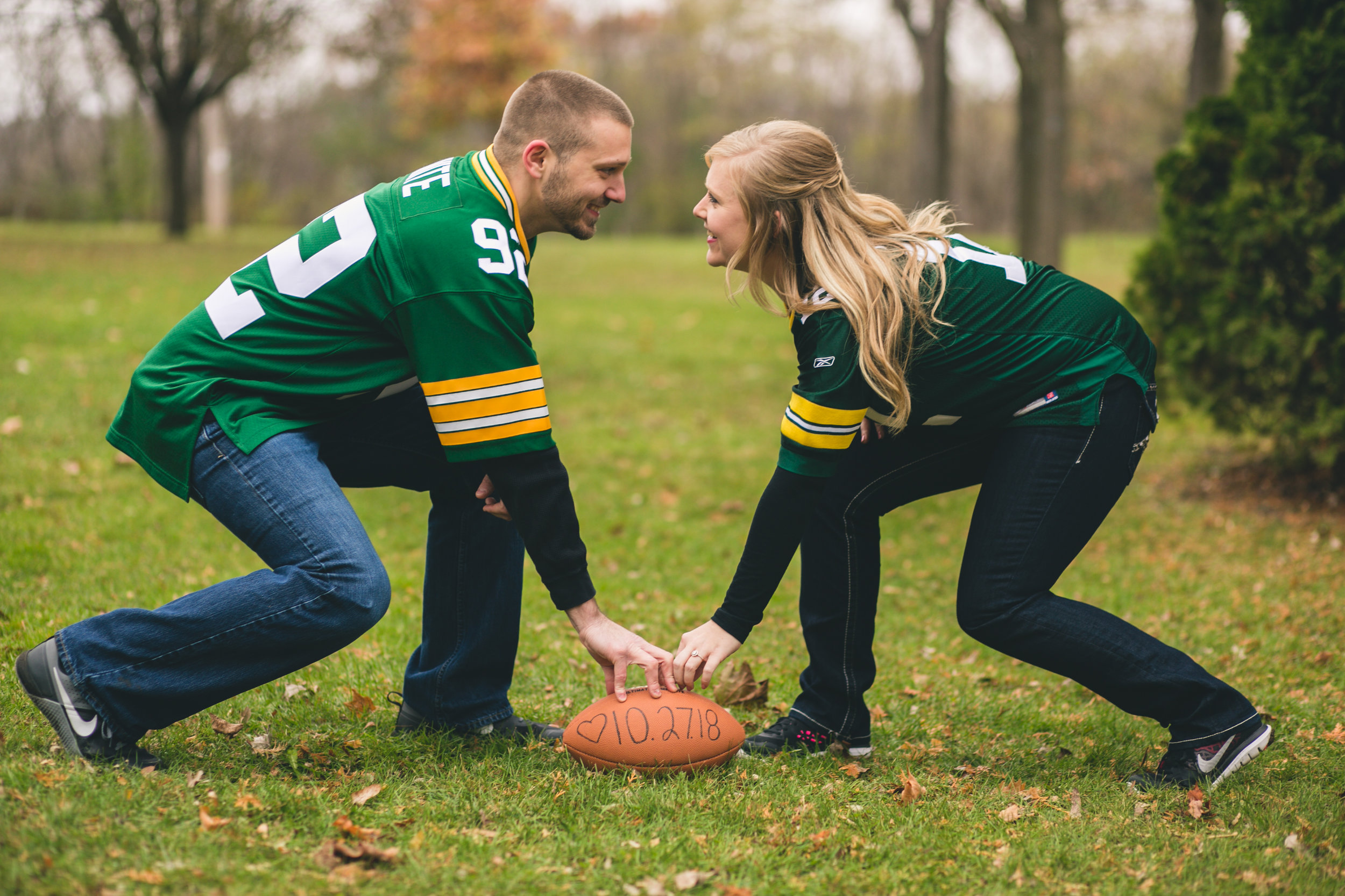 couple wearing Green Bay Packer jerseys for engagement photos