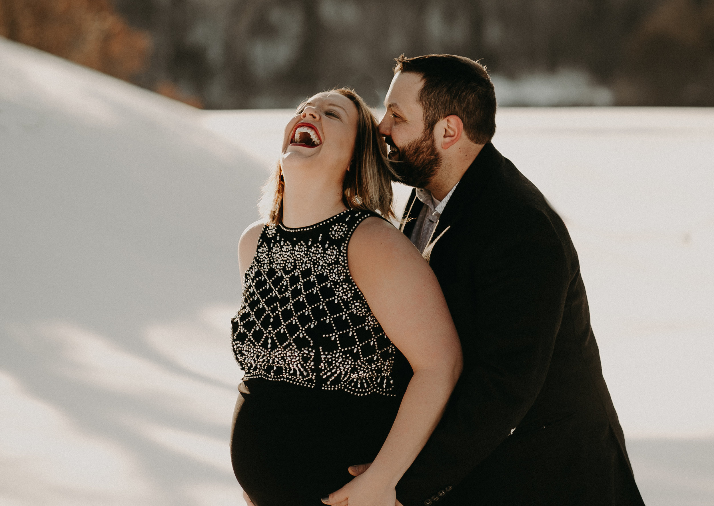river falls wi man making pregnant wife laugh in snow maternity photoshoot