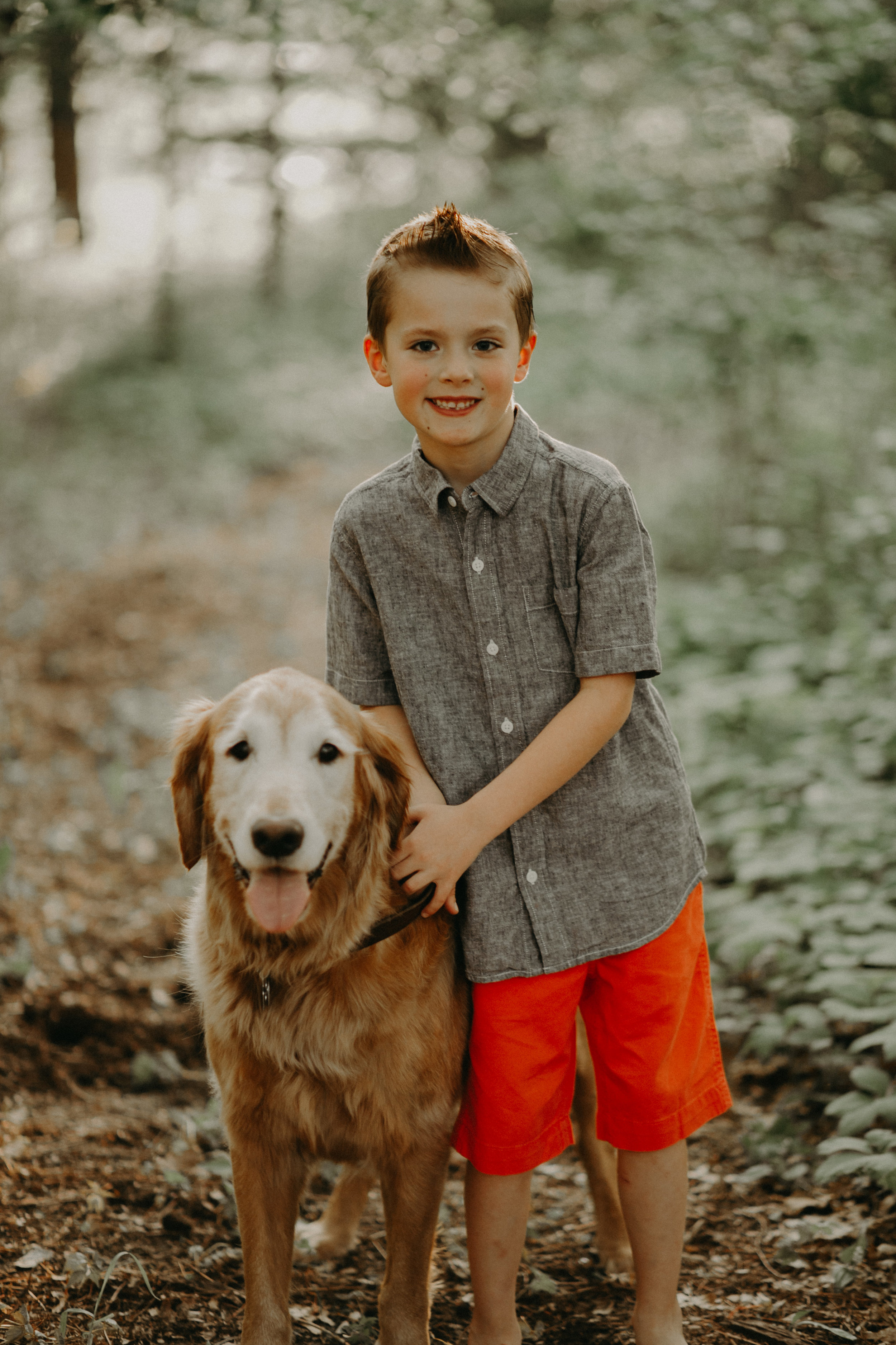 young boy in River Falls WI with Golden Retriever smiling 