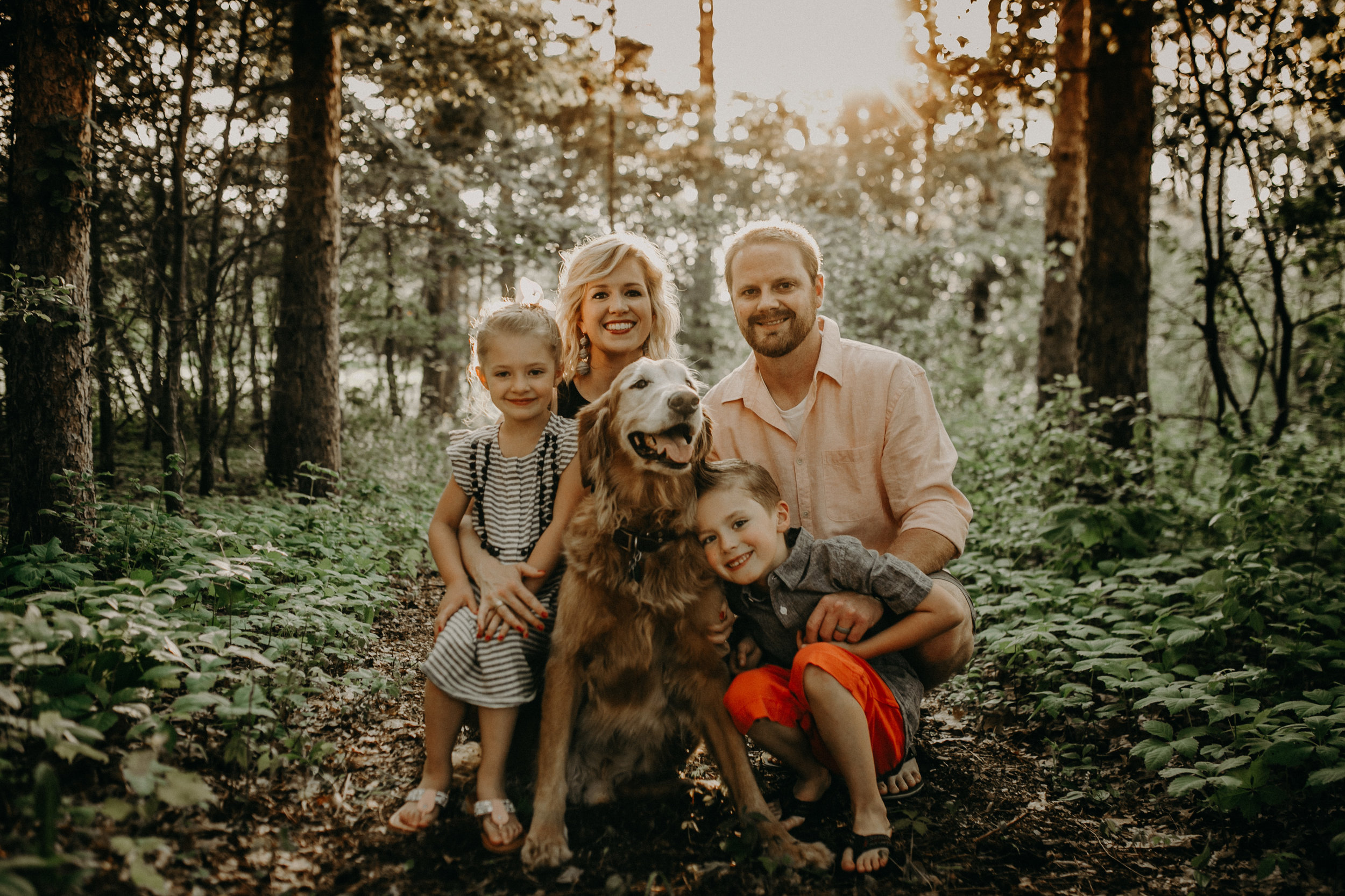 family in River Falls smiling during photo shoot with golden retriever with cancer