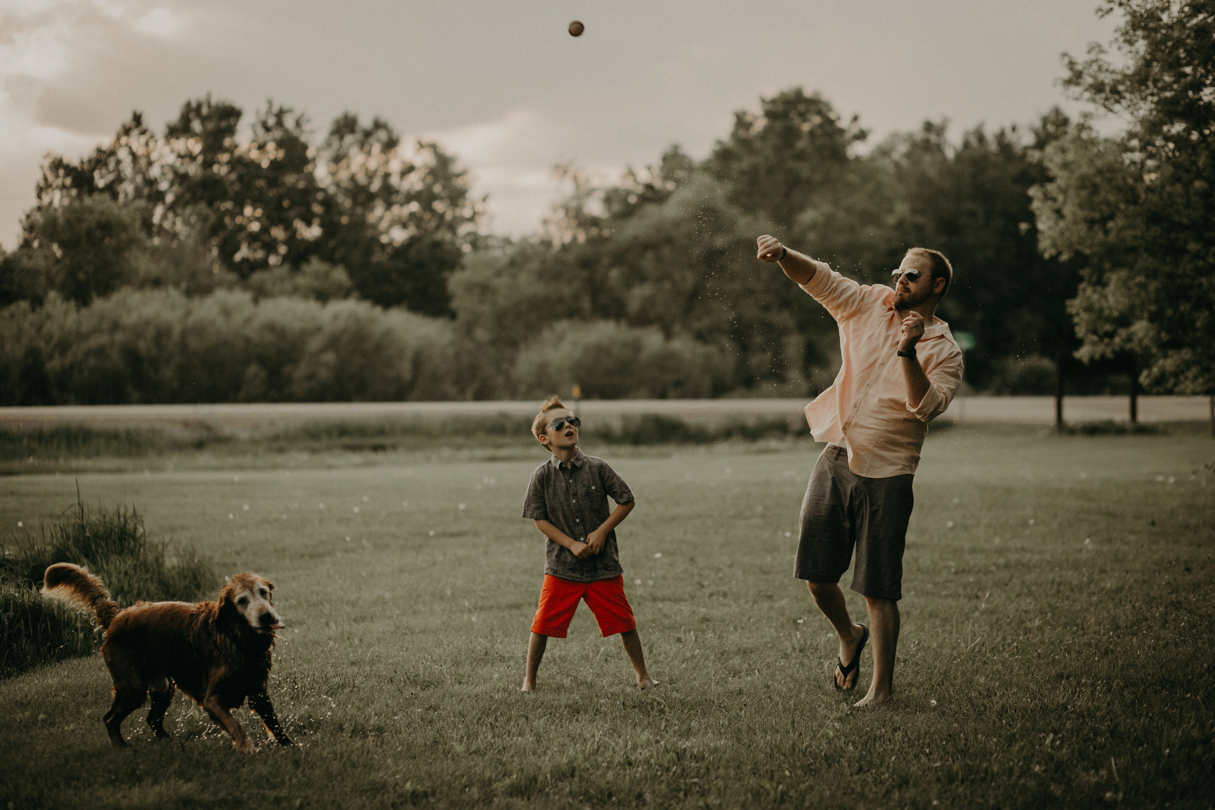 River Falls dad throwing a ball to his golden retriever pup