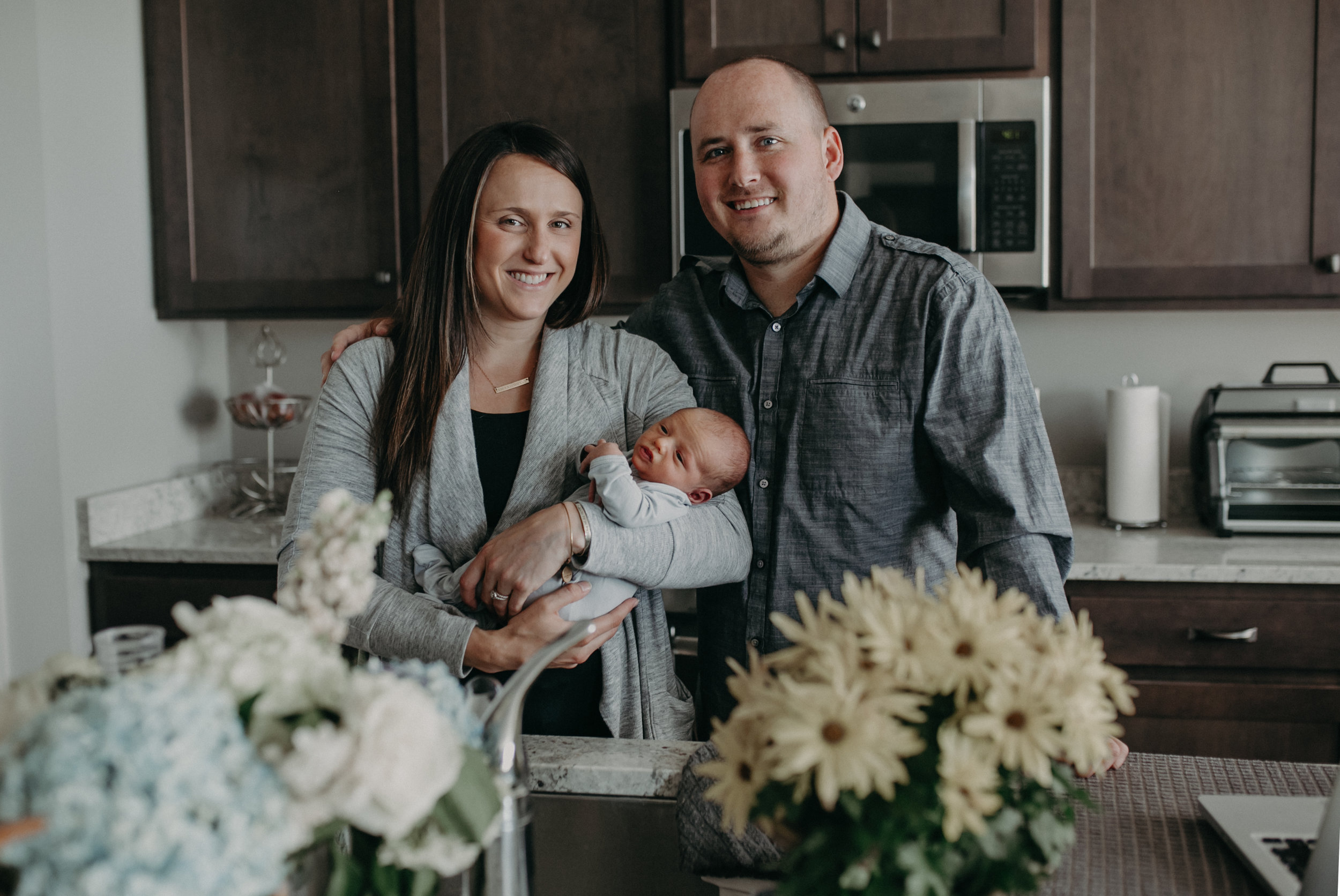  new parents holding baby boy in Chaska MN in their home 