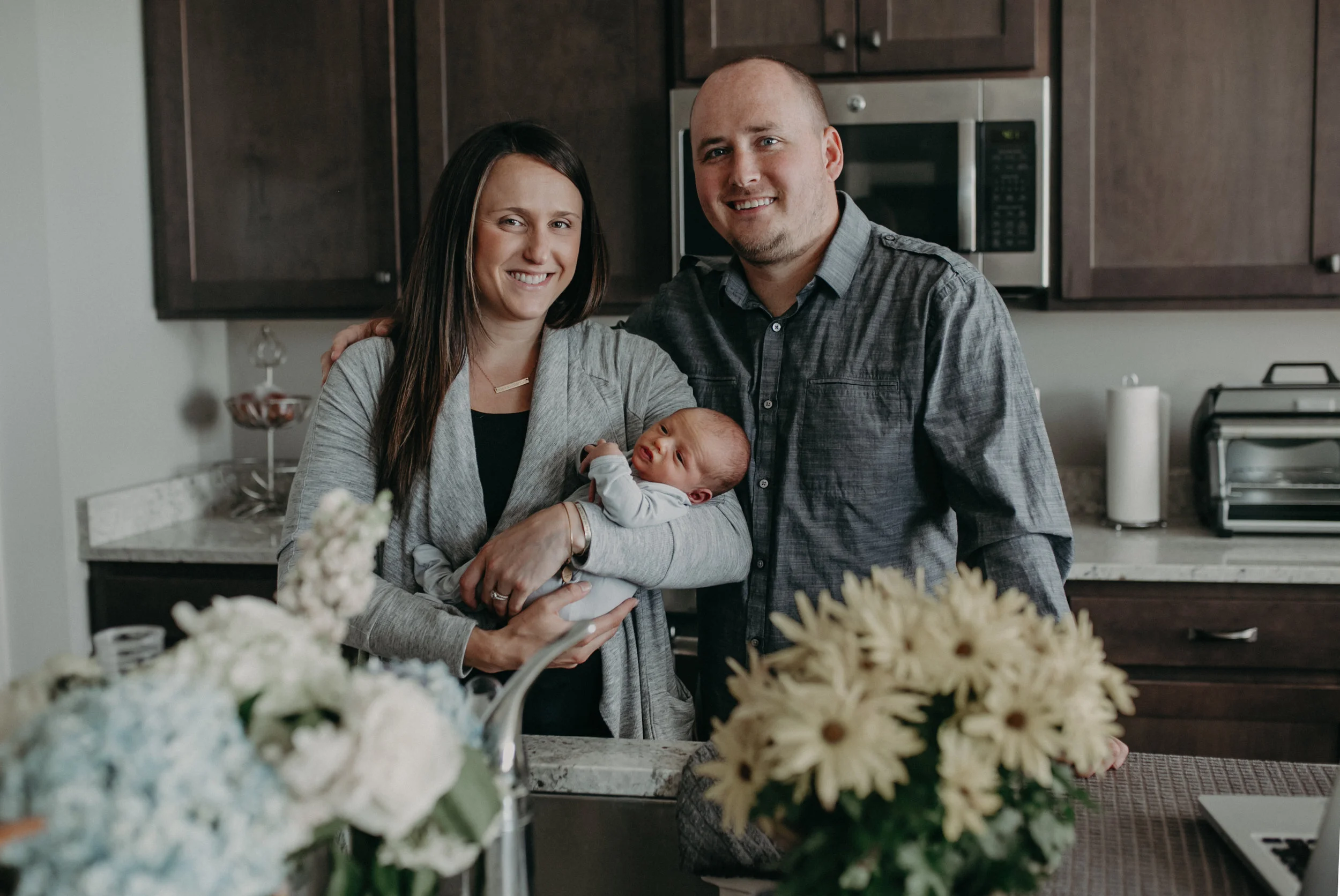 new parents holding baby boy in Chaska MN in their home