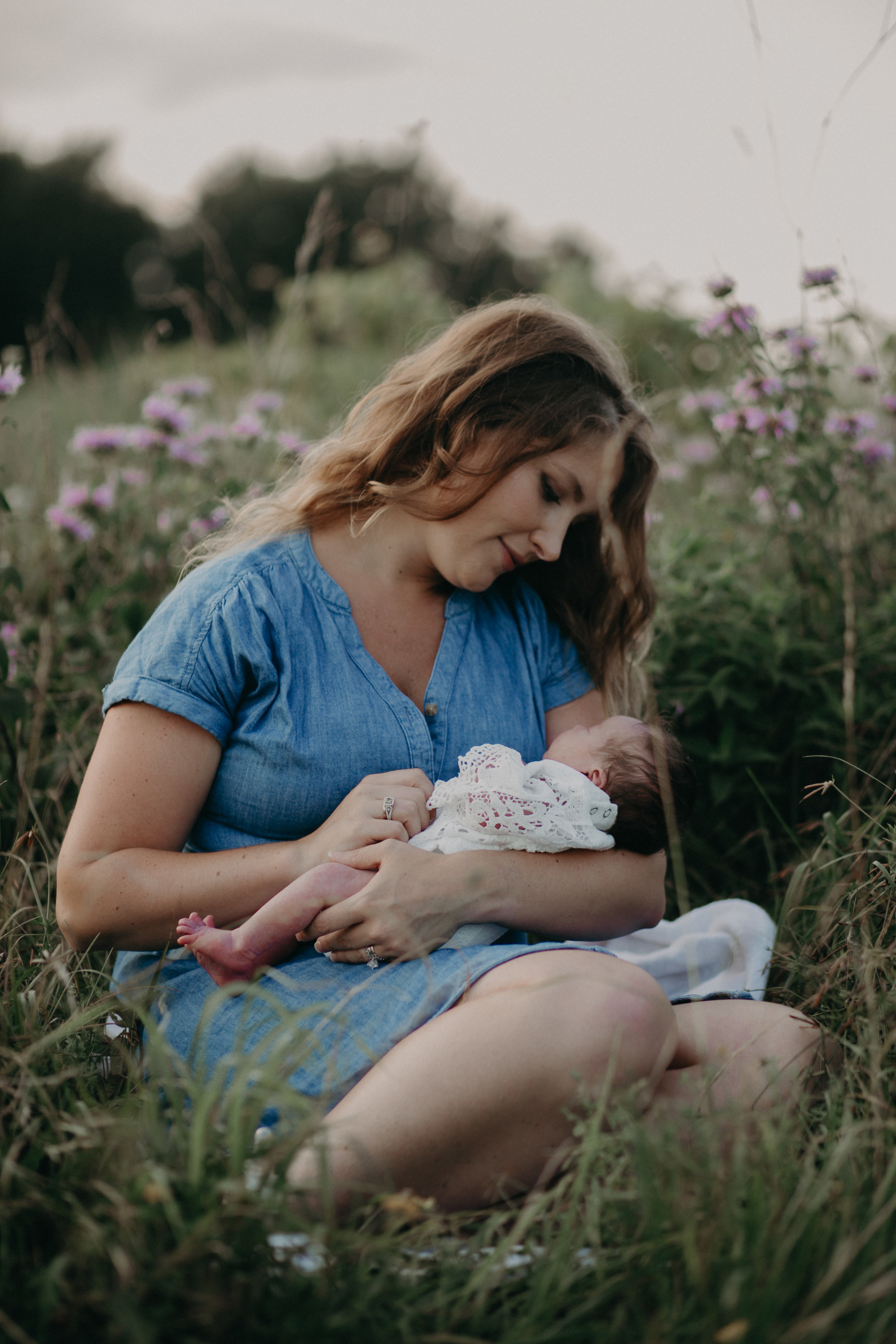 Mommy and baby girl in field of flowers