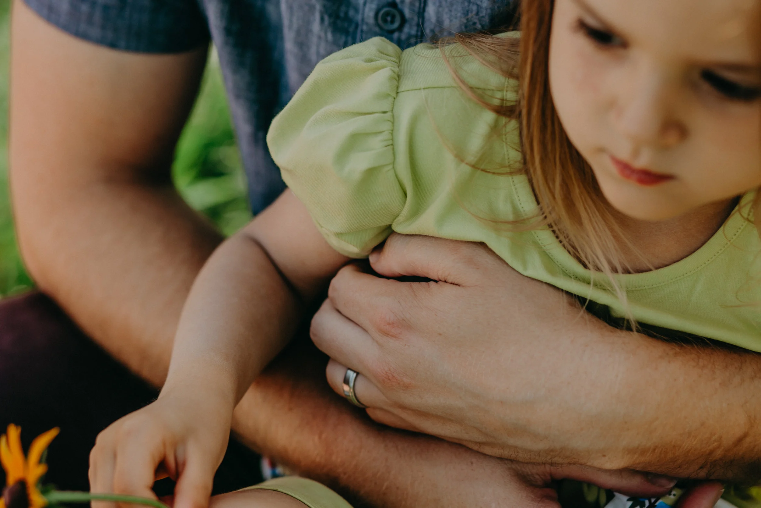  daughter being held by daddy’s hands in River Falls 