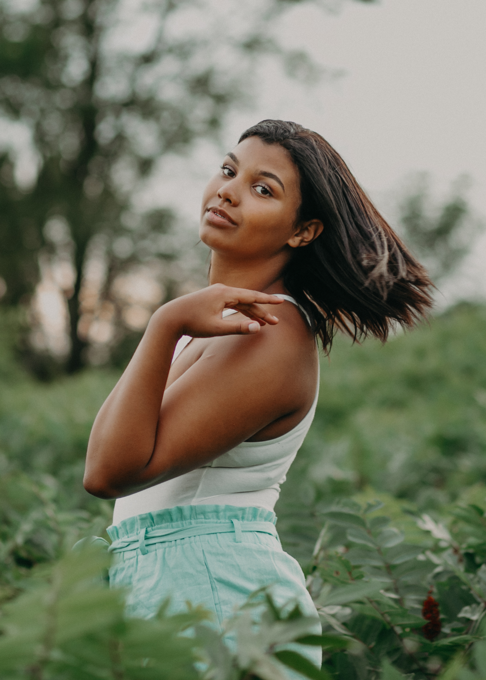 black girl flipping her hair during a high school senior session in Hudson WI