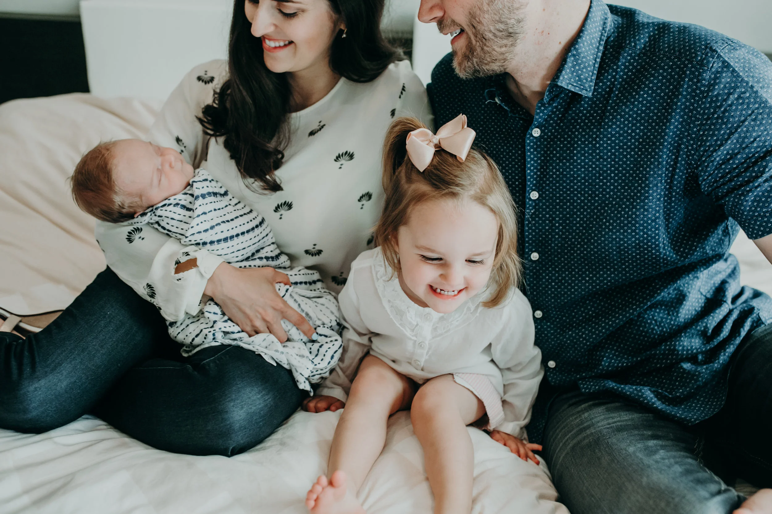 laughing family during a lifestyle newborn photo session in central Wisconsin