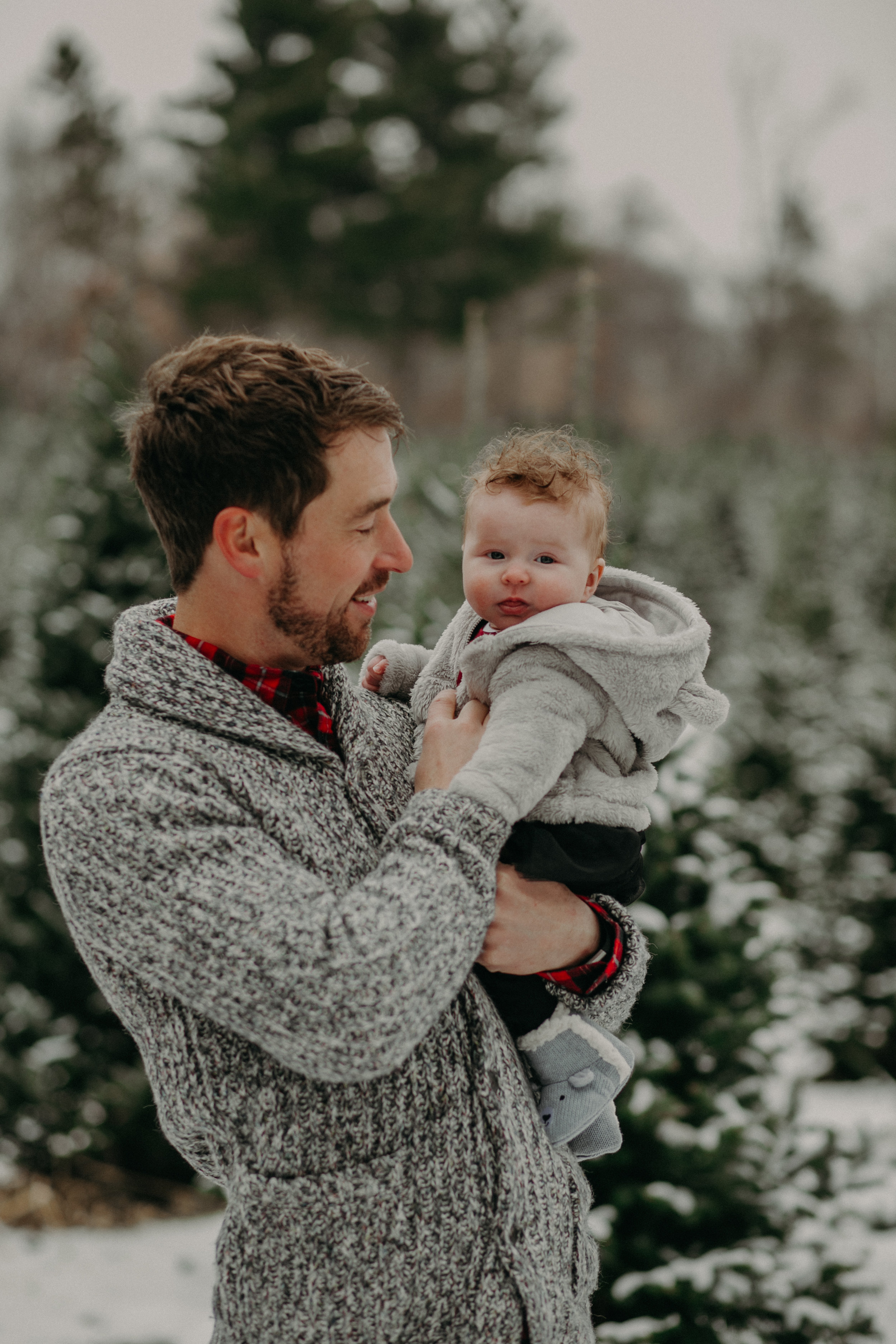  daddy and baby daughter at Christmas tree farm in Hudson WI 