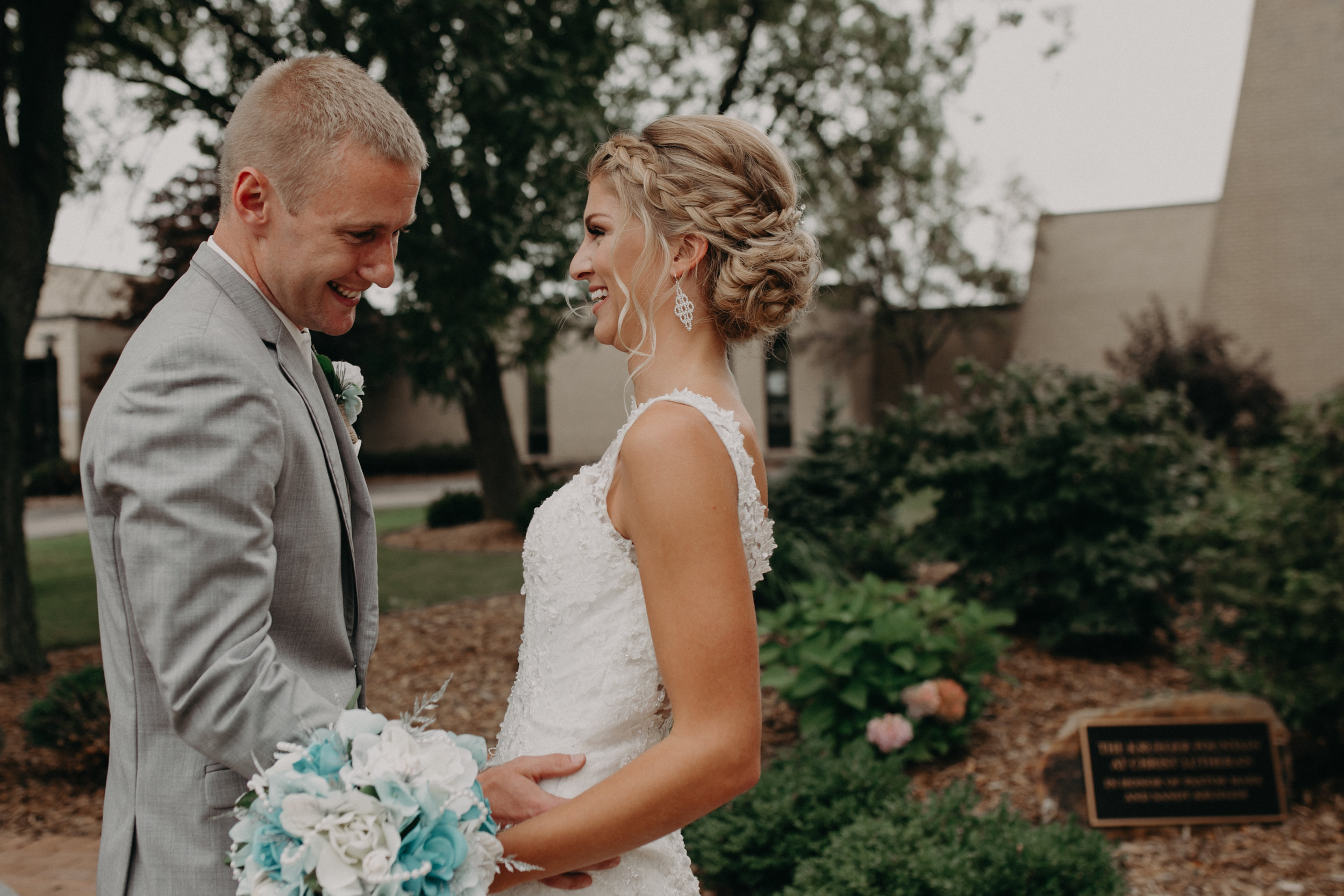  groom blushes as he sees his bride for the first time before his wedding at Christ Lutheran Church in Marshfield WI 