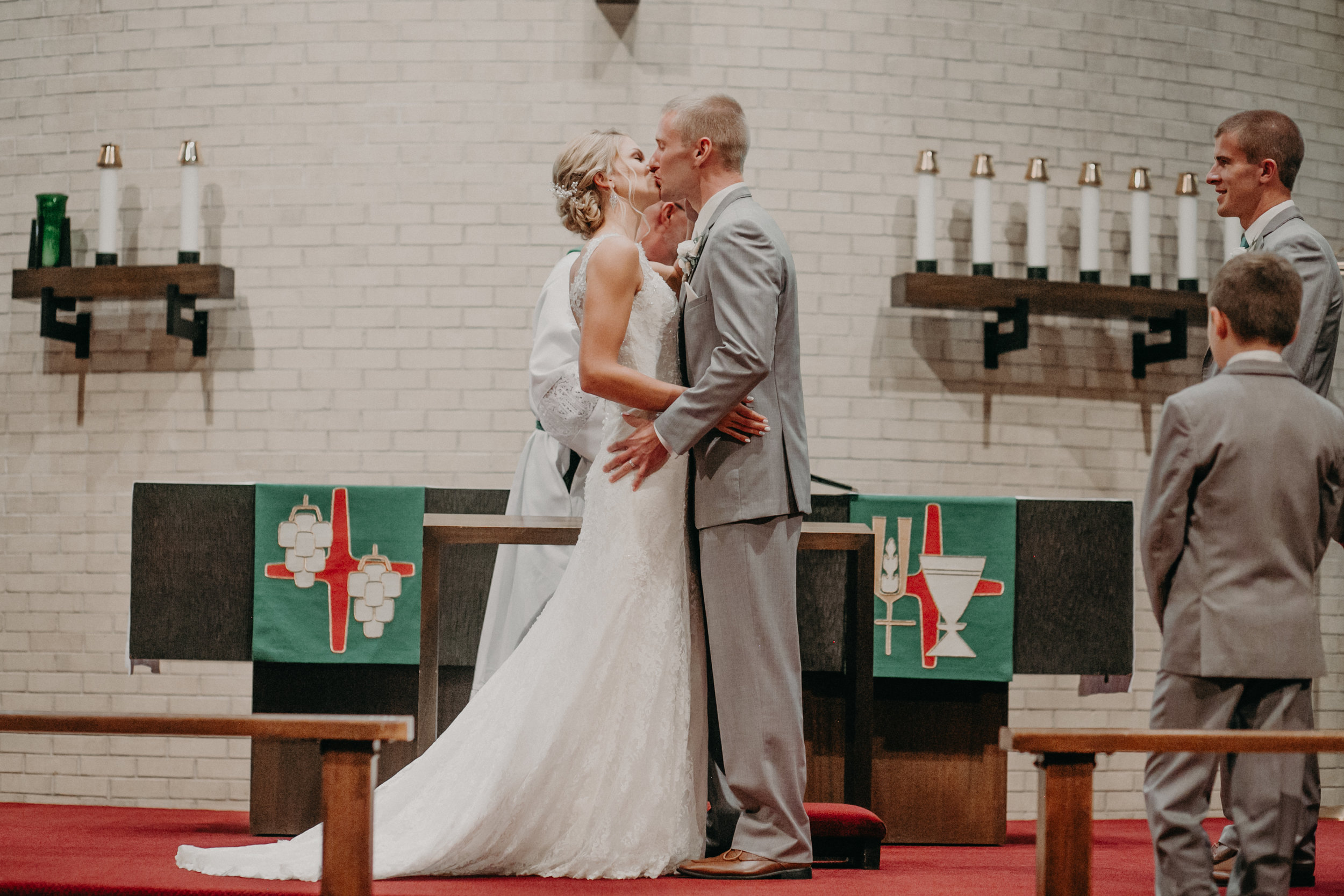  bride and groom’s first kiss at Christ Lutheran Church in Marshfield WI 